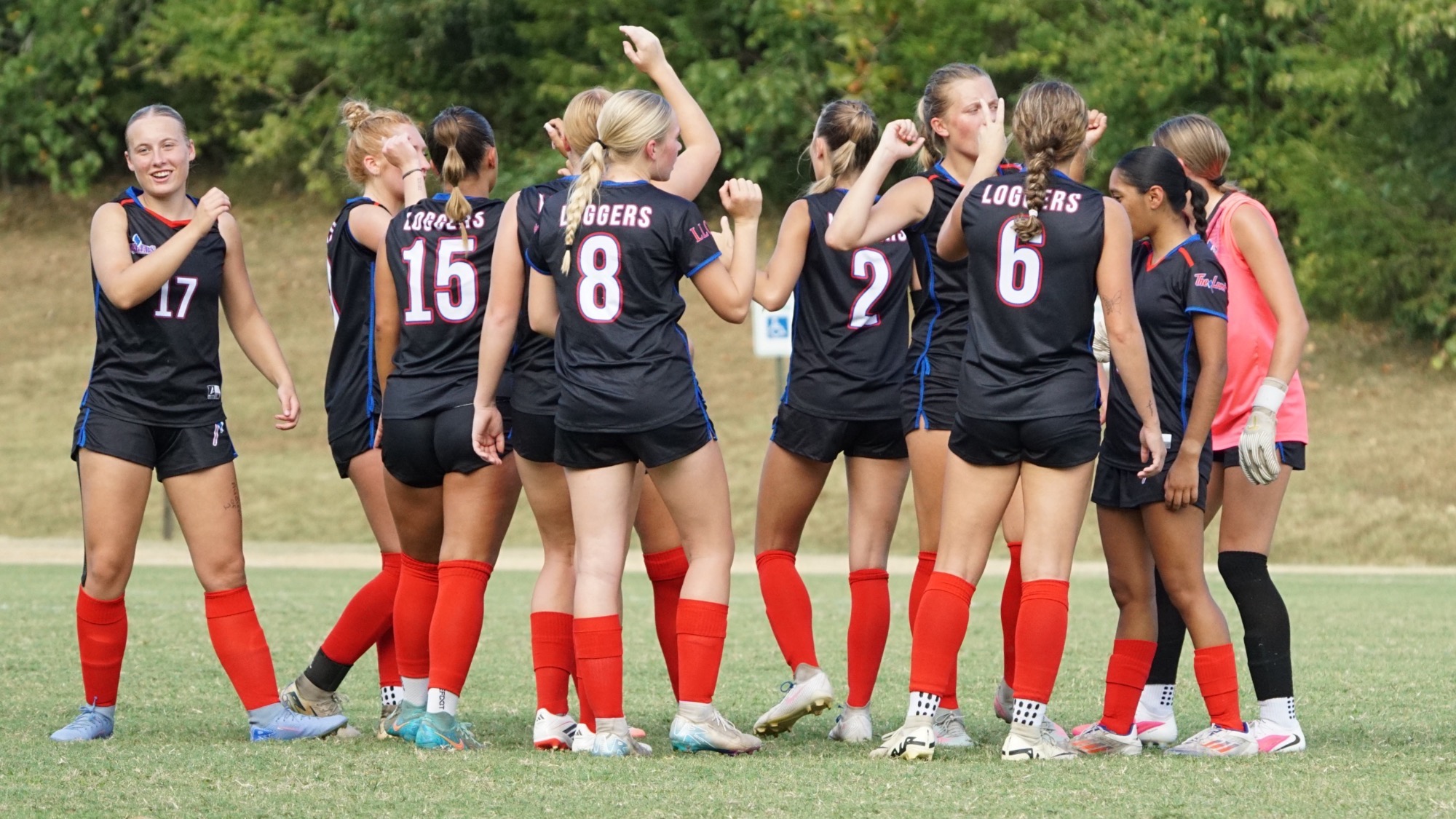 LLCC women's soccer team standing around.