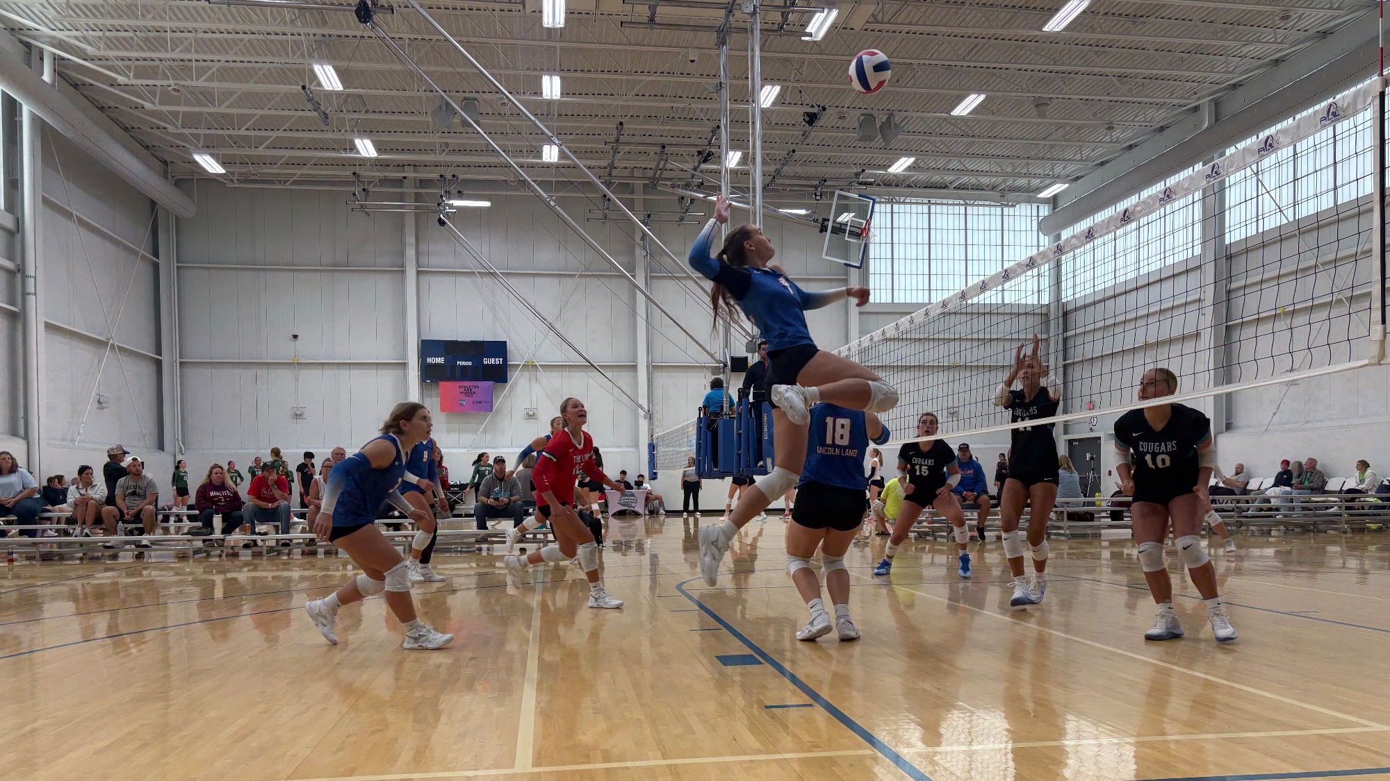 LLCC women's volleyball team playing volleyball.