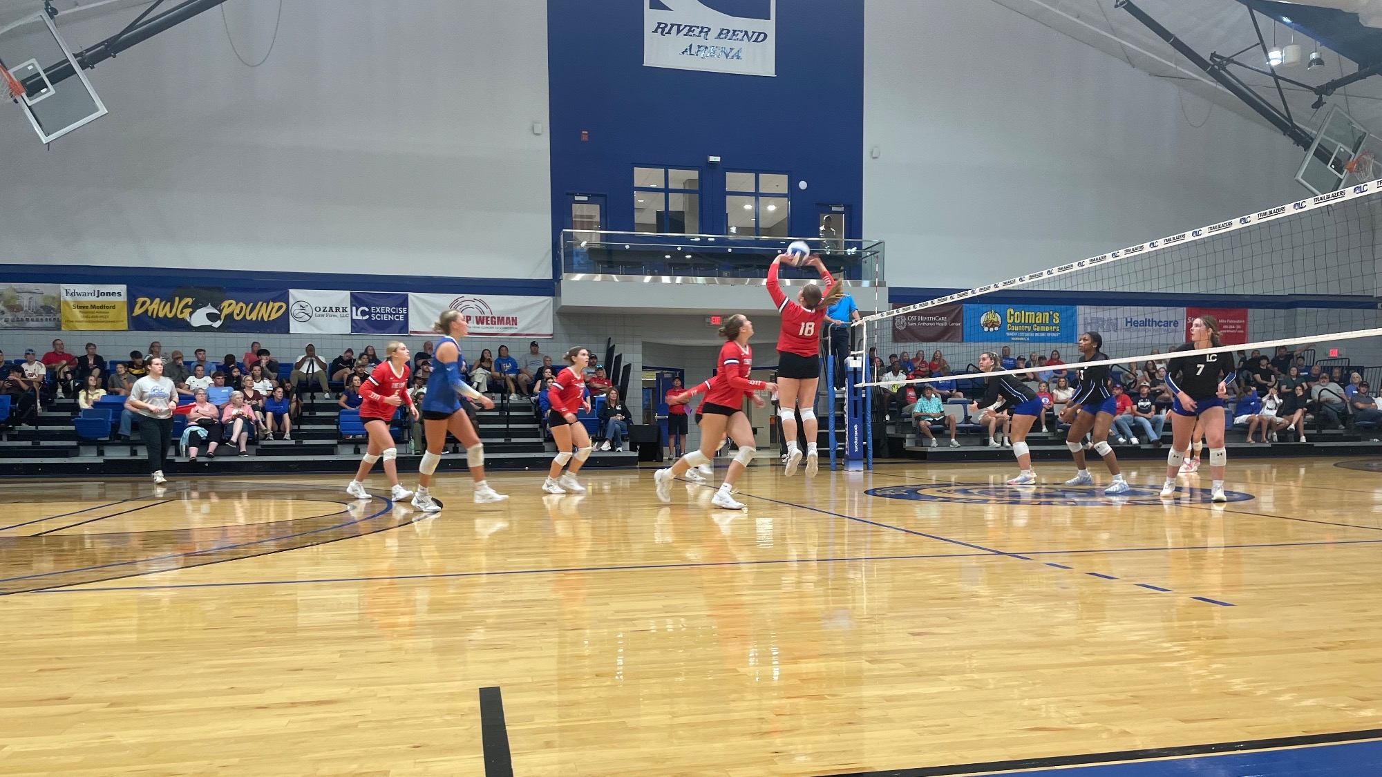 LLCC women's volleyball playing volleyball.