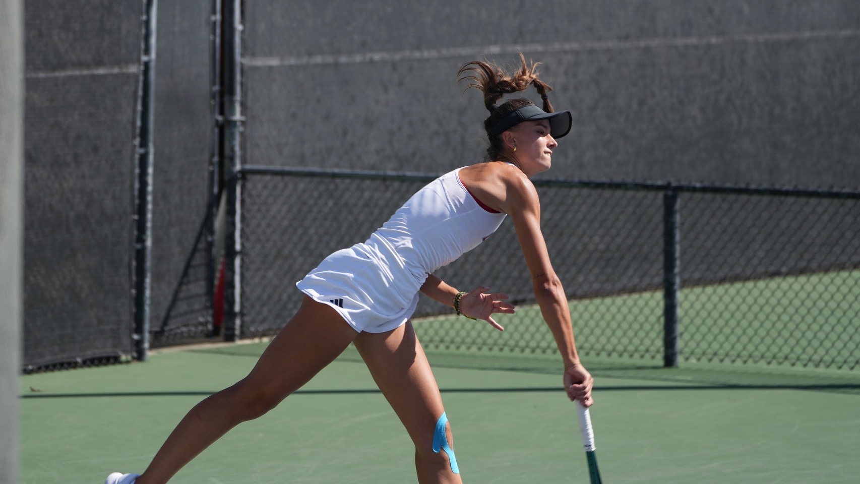 Lidia finishes her serve