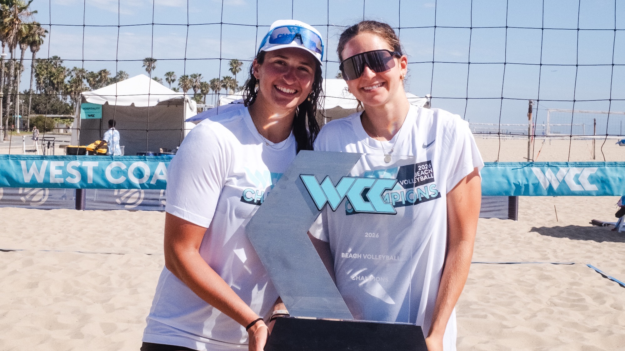 Anna Pelloia and Tanon Rosenthal Holding WCC Trophy after Winning 2026 Beach Volleyball Championship