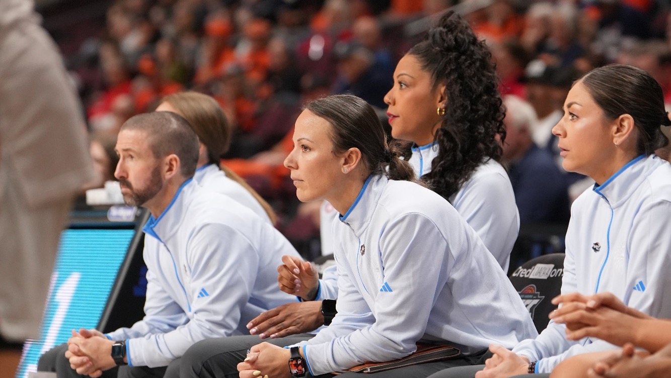 WBB Coaches Sitting On Bench