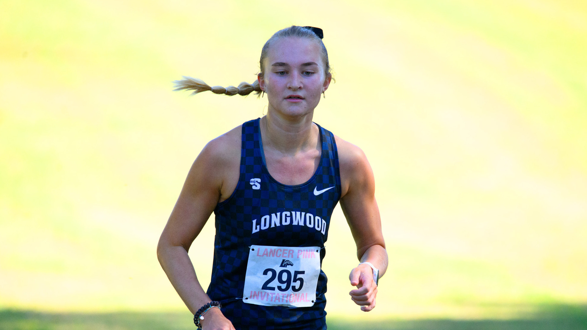 Kiersten Witte runs to the finish line in the Lancer Pink Invitational