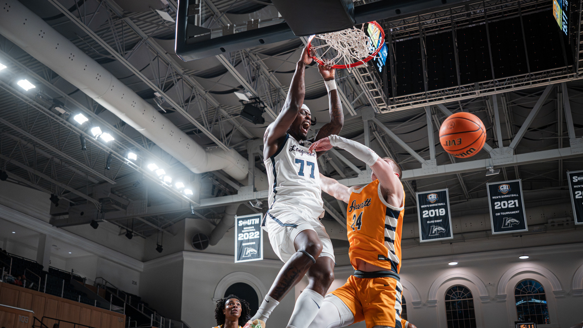Elijah Tucker dunks the basketball