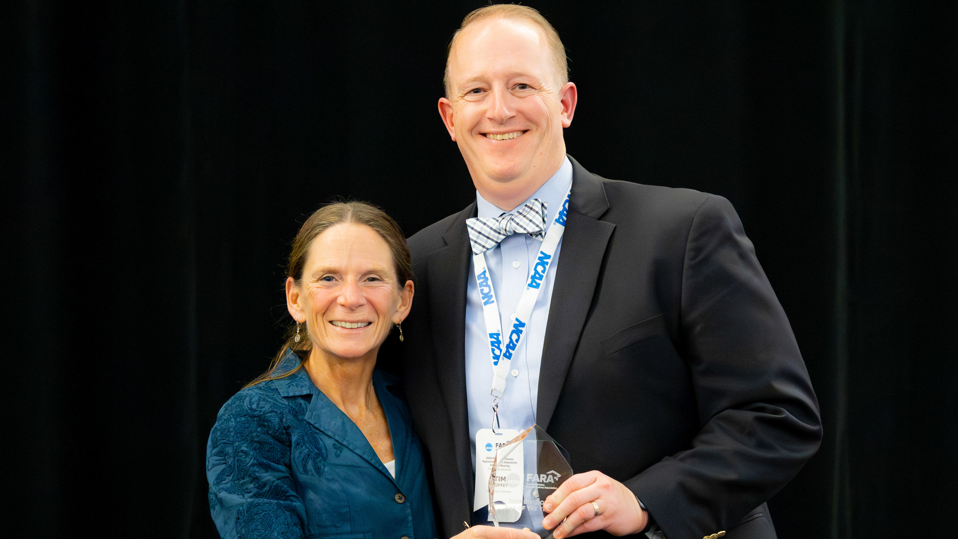 Dr. Tim Coffey is presented his Faculty Athletics Representative of the Year award by Dr. Pam Bruzina, President of FARA