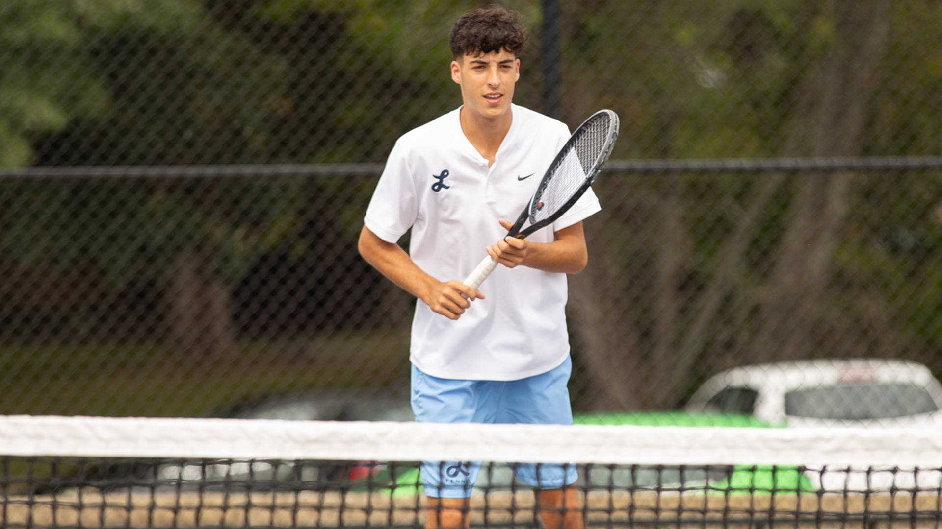 Rodrigo Guijarro waits at the net during doubles practice