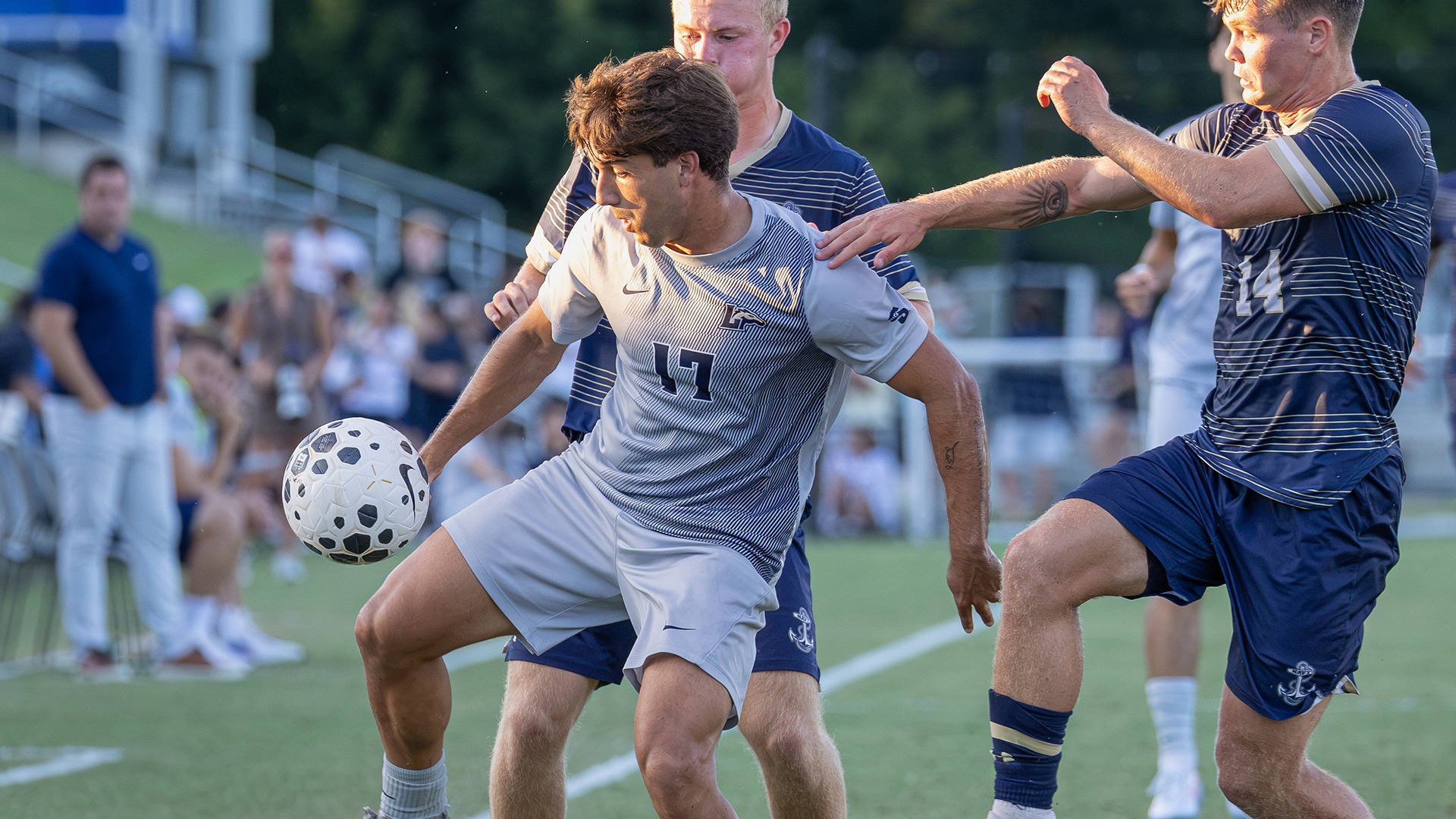 Vicent Martinez battles for the ball against two Navy defenders in the Lancers home game against the Mids on Sept. 15, 2026. 