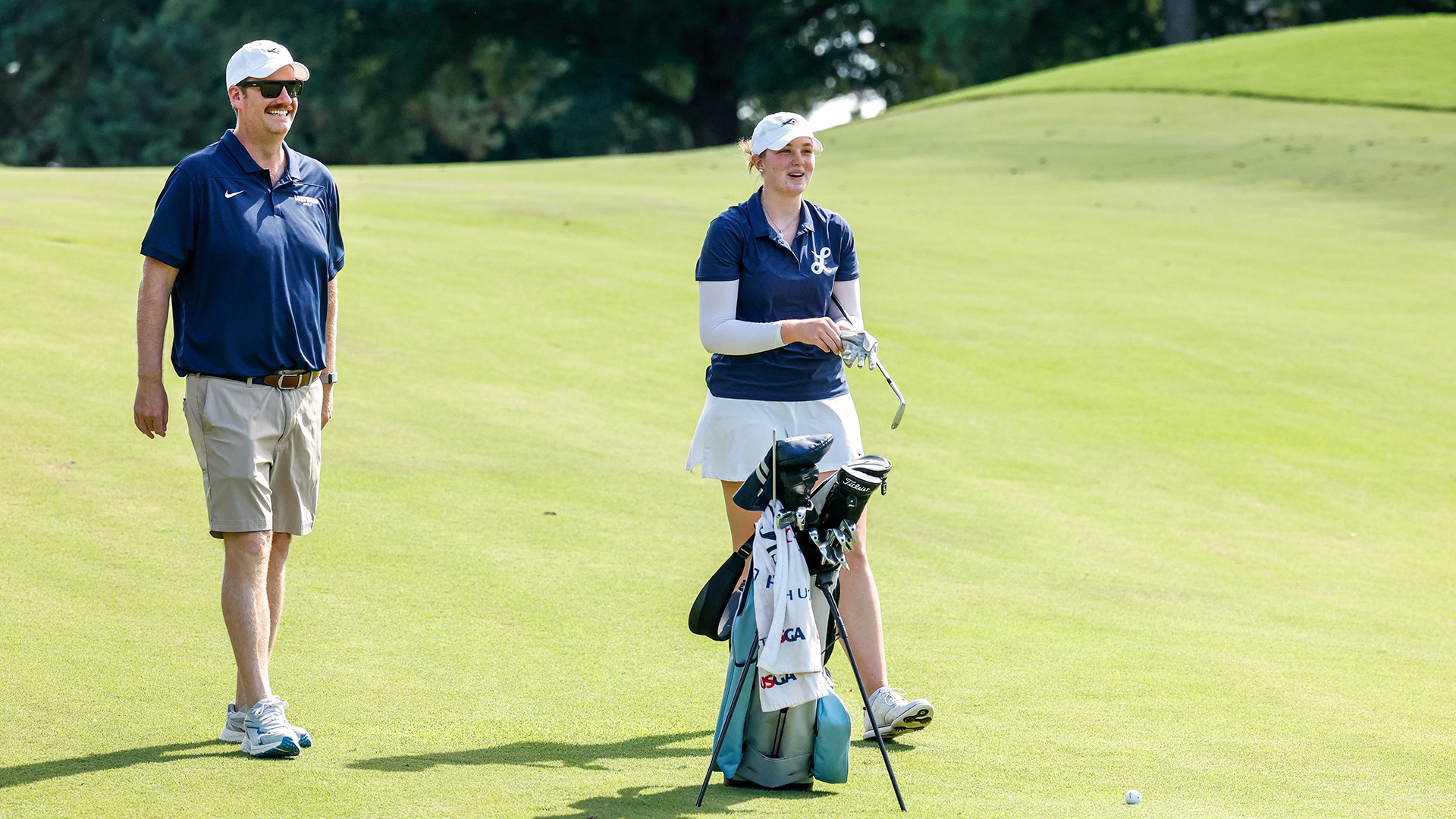 Avery Nordman and graduate assistant coach Brooks Ward share a laugh in the middle of the fairway during a practice round at the Tribe Invitational.
