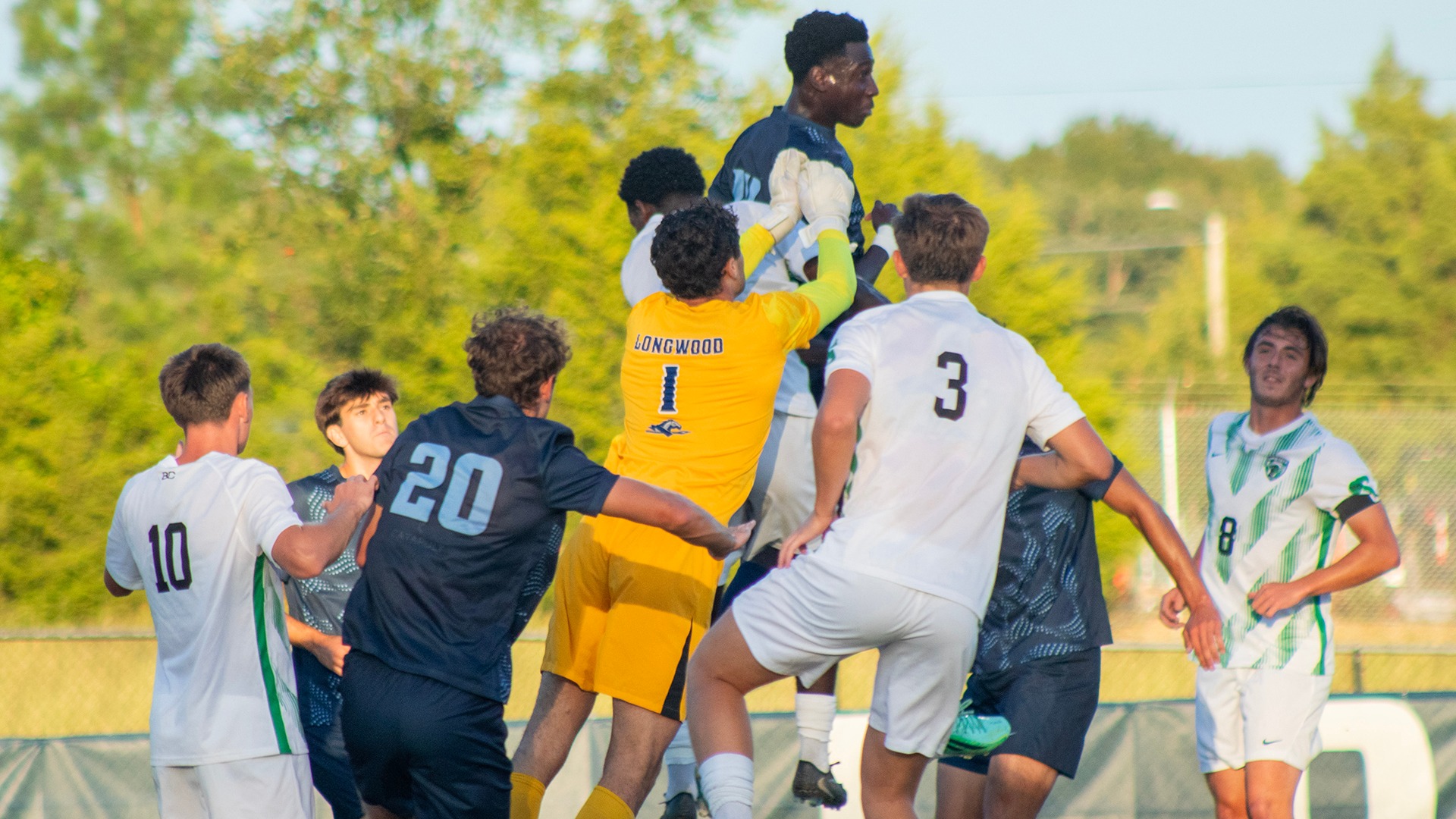 Mamadou Seck elevates over everyone as Nicolas Pucci jumps to punch away a cross in Longwood's home win over USC Upstate. 