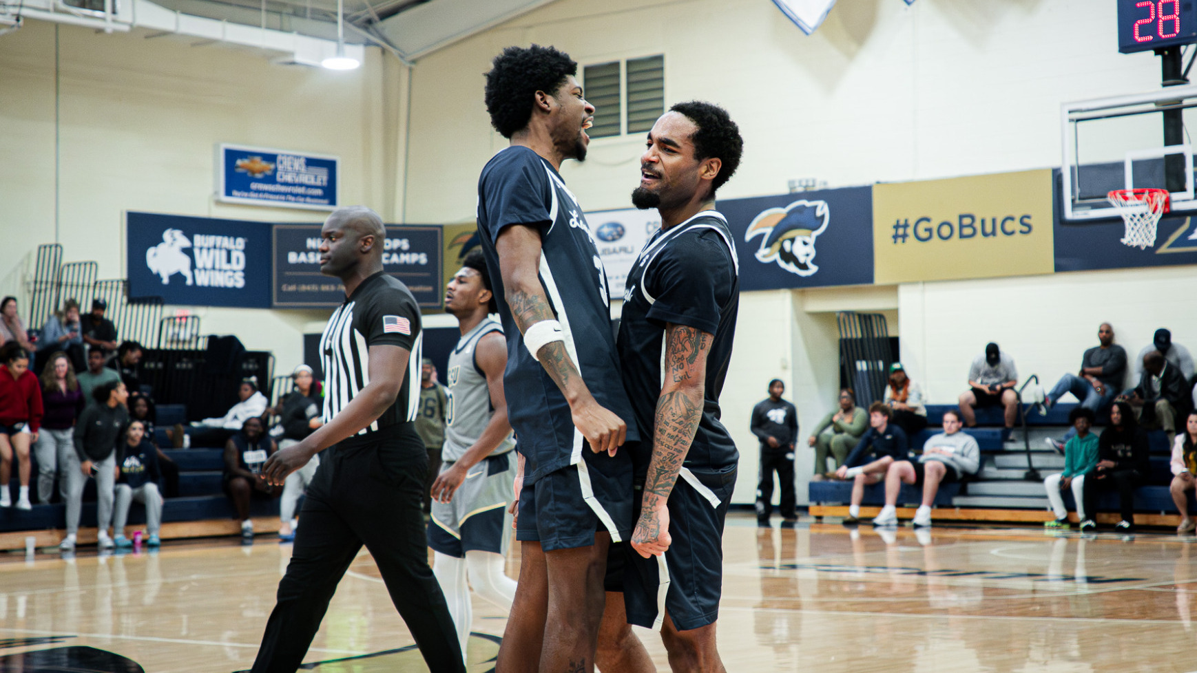 Jacoi Hutchinson celebrates with Fats Billups for Longwood