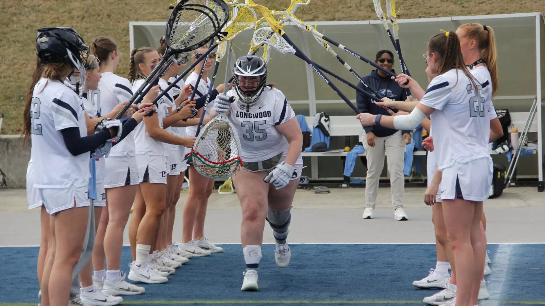 Isabella McCullough runs through the starting line for Longwood women's lacrosse
