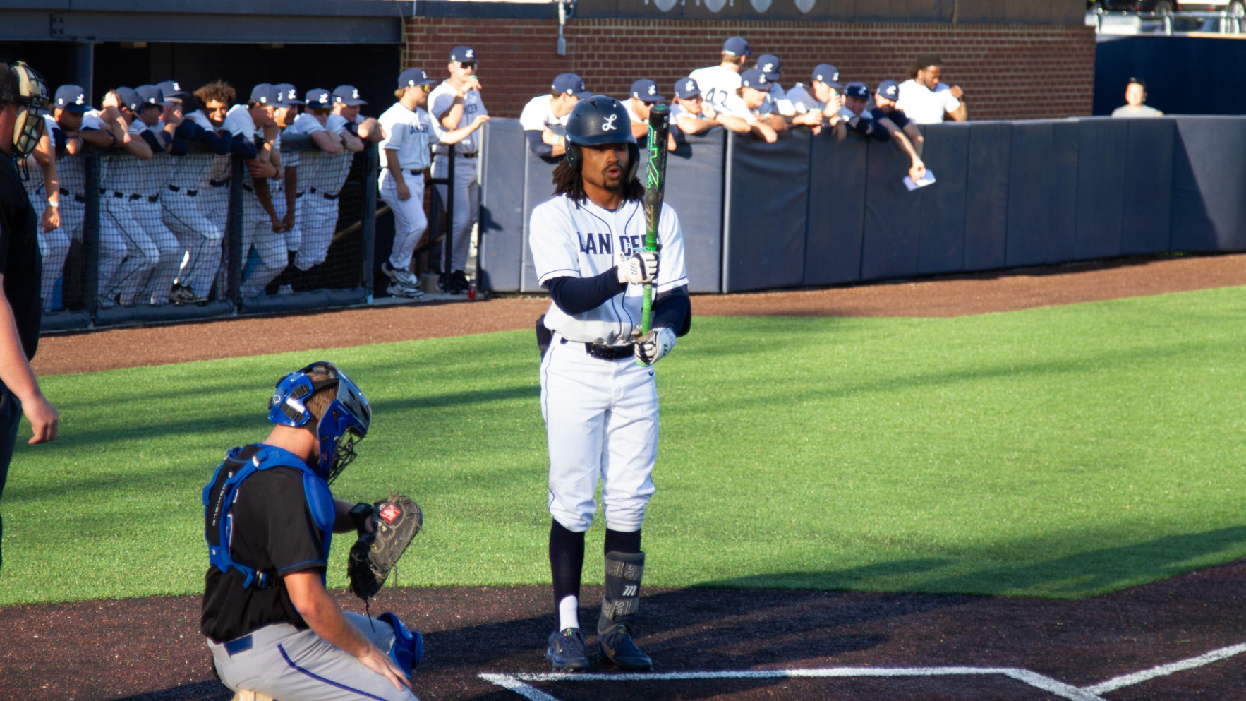 Jae'dan Carter looks at his bat as he prepares to step into the box