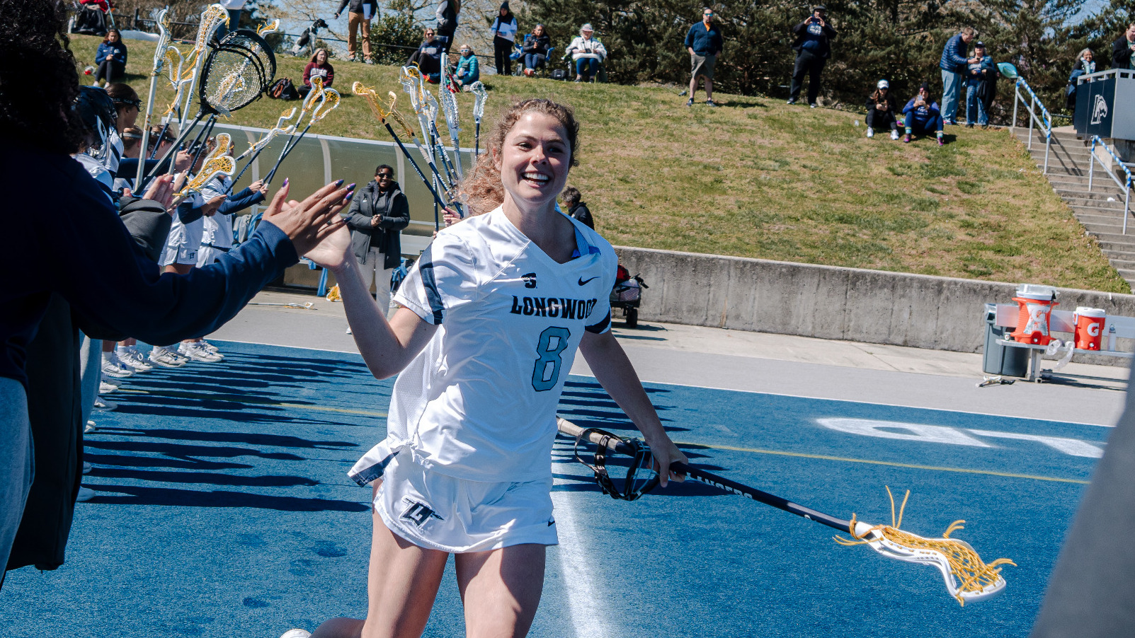 Alexandra Burst high fives her teammates and coaches