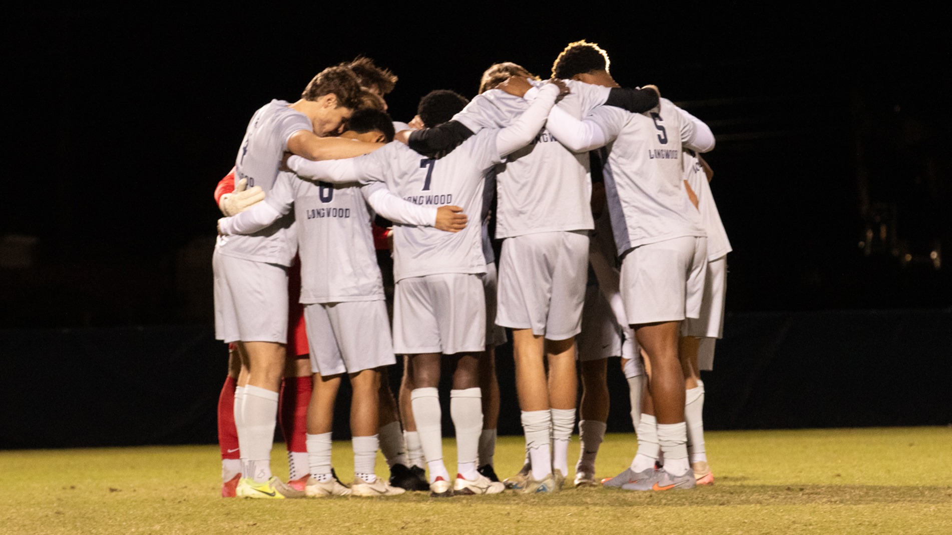 The Lancer starting lineup huddles up prior to its Senior Day in 2025. 
