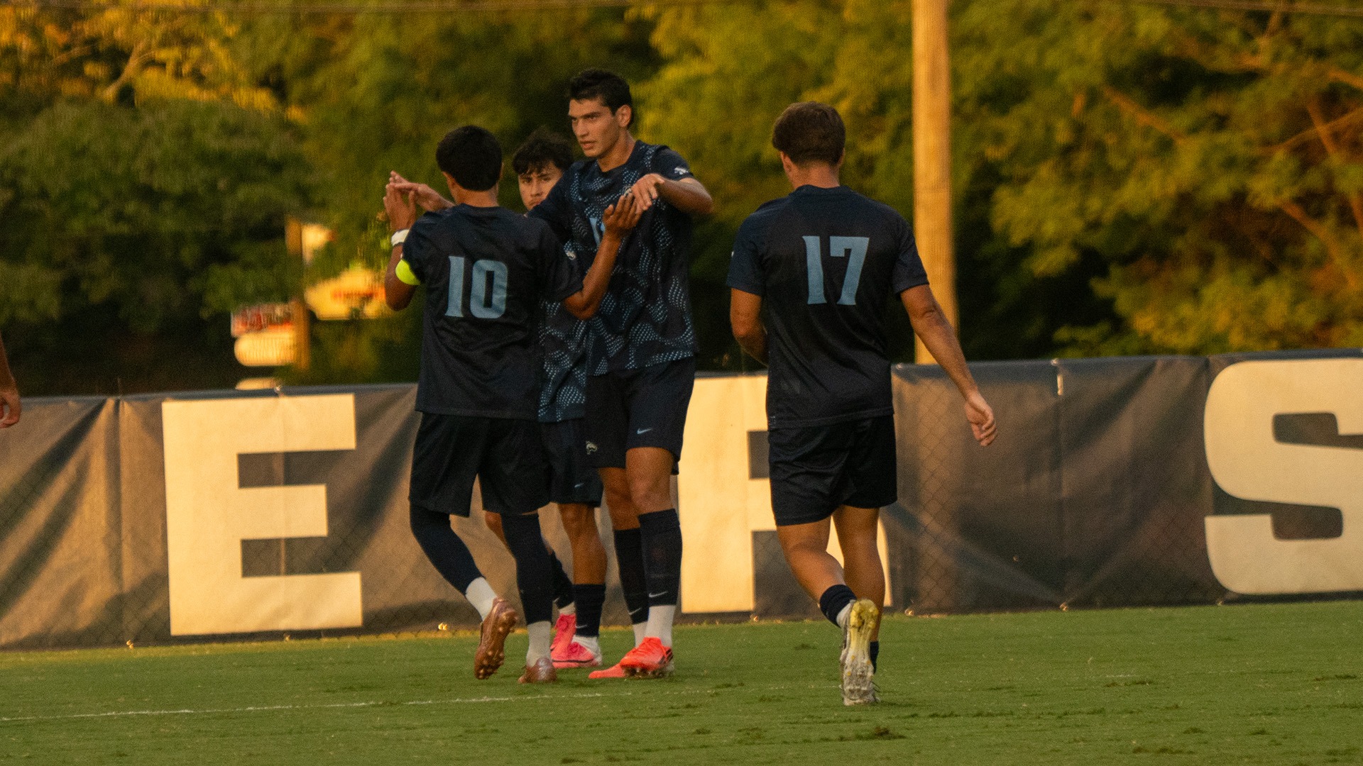 Levon Saribekyan high fives Brando Bedolla near midfield after scoring his goal to give Longwood a 2-0 lead over Southern Virginia. 