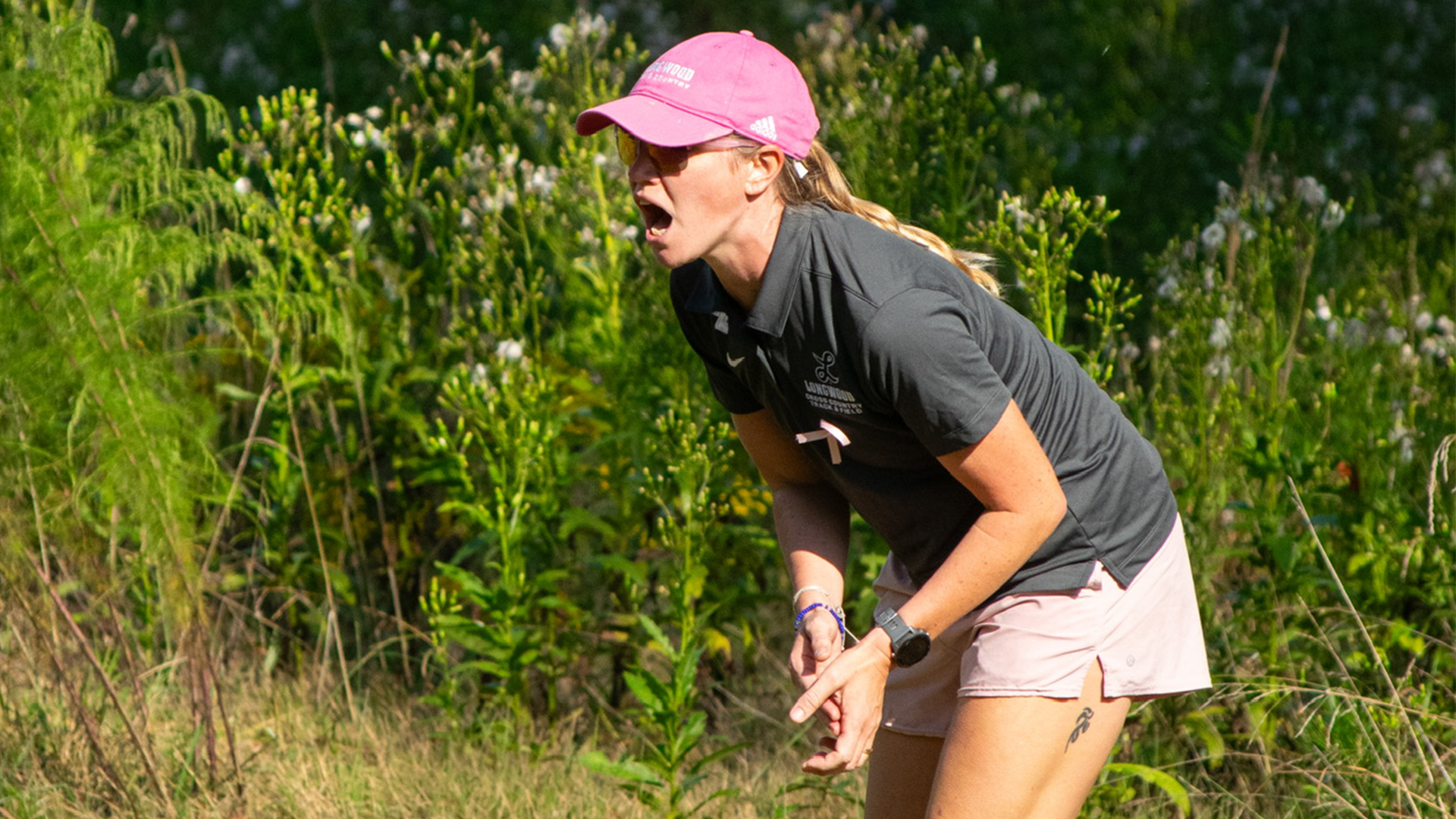 Director of Cross Country Brooke Craig encourages runners during a 2025 meet.