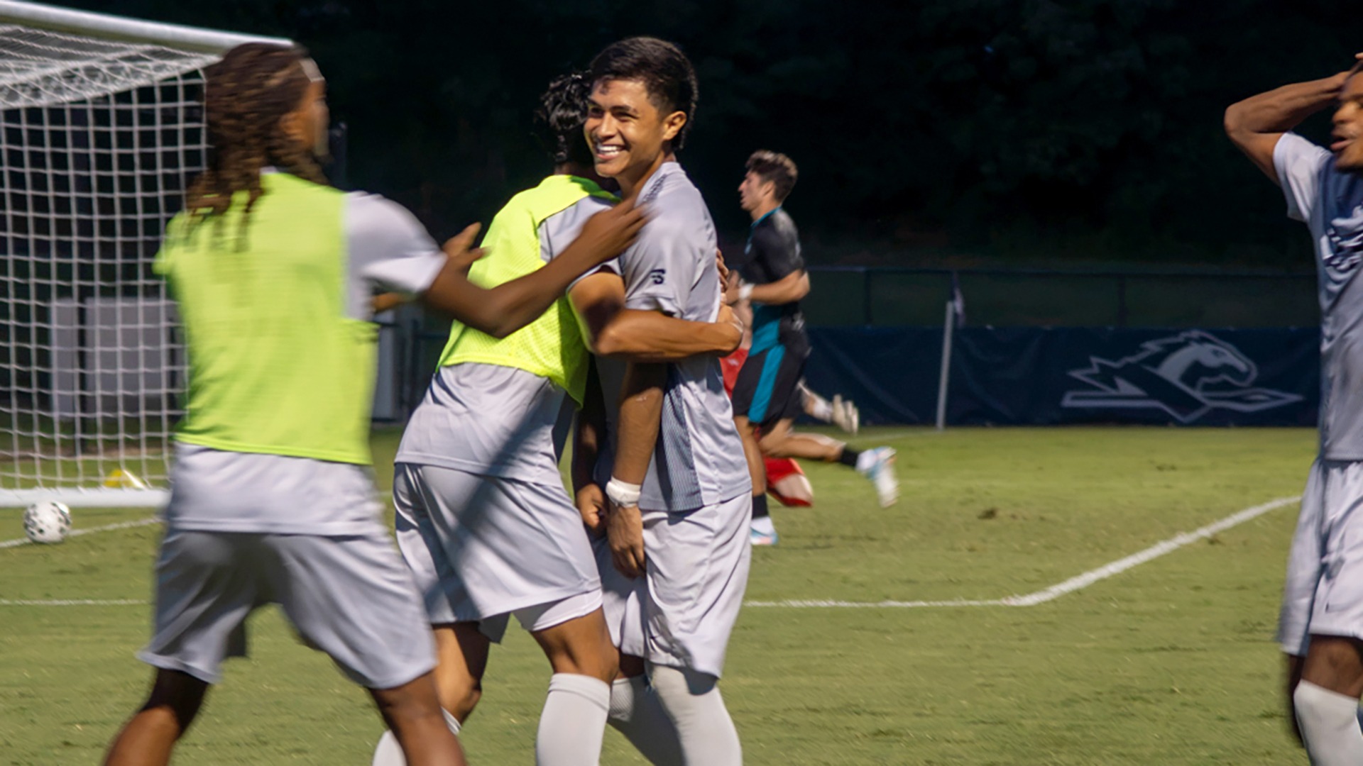 Brando Bedolla gets hugged by a teammate and smiles after scoring Longwood's fourth goal in the Lancers' 4-2 win over Coastal Carolina at the Longwood Athletics Complex on Aug. 24. 