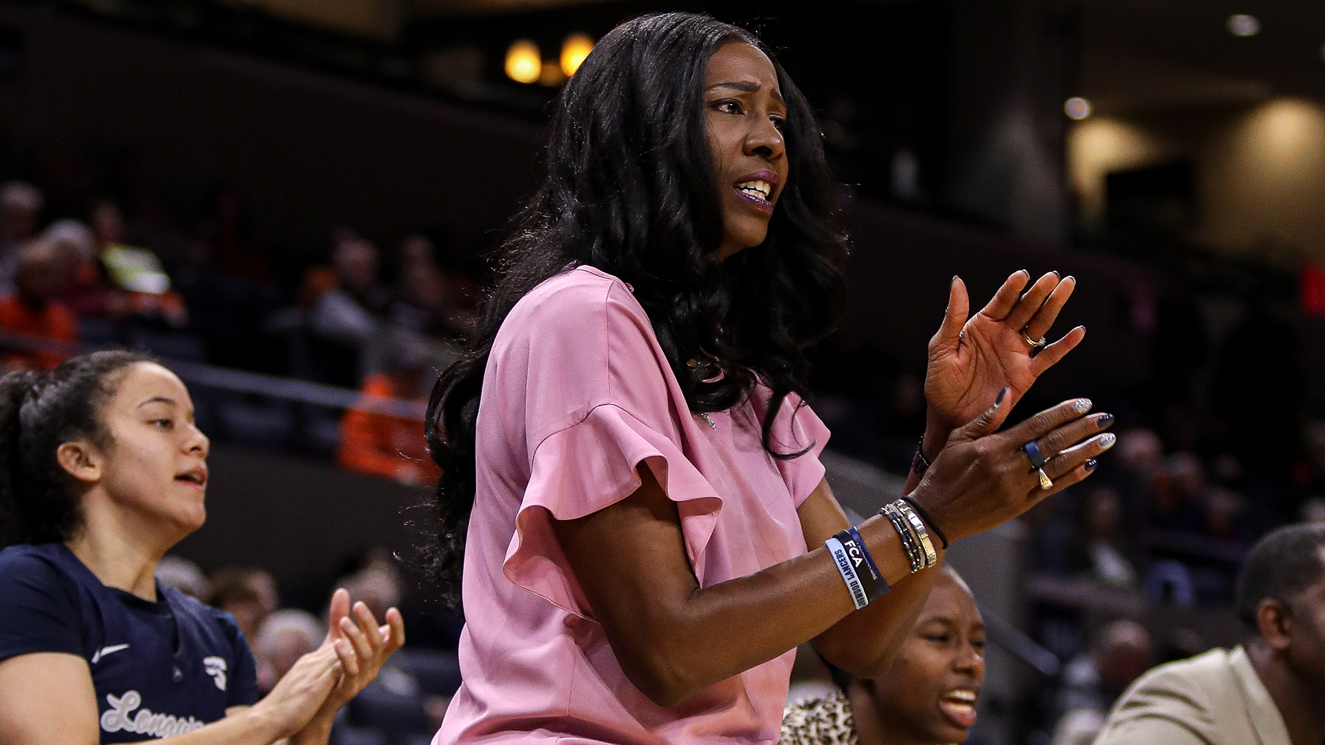 Erika Lang-Montgomery coaches on the sideline in a November 20, 2025 game at Virginia