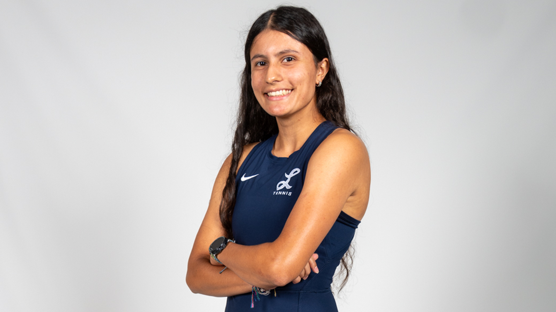 Hima Fernando poses with her arms folded with a smile