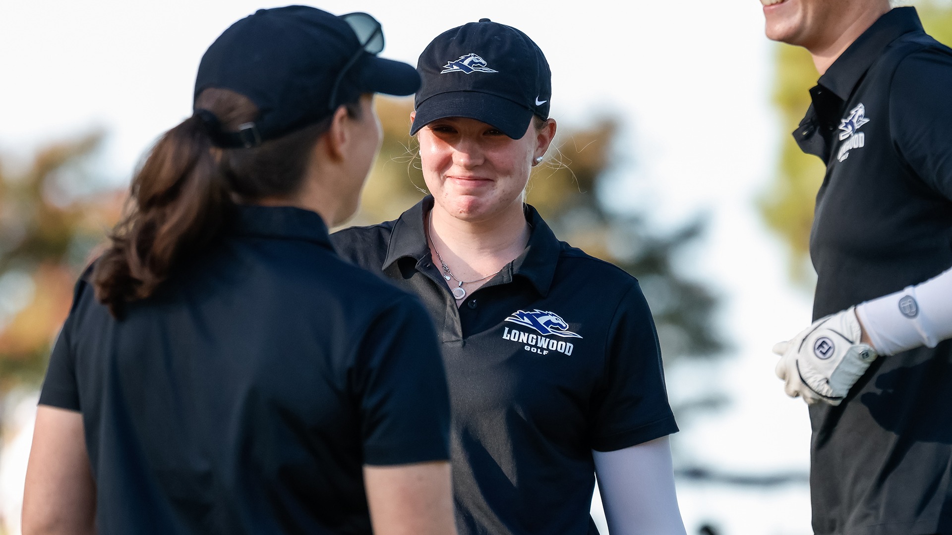 Avery Nordman smiles while talking to head coach Megan Weaver ahead of the Lancers' final round at the Tribe Invitational