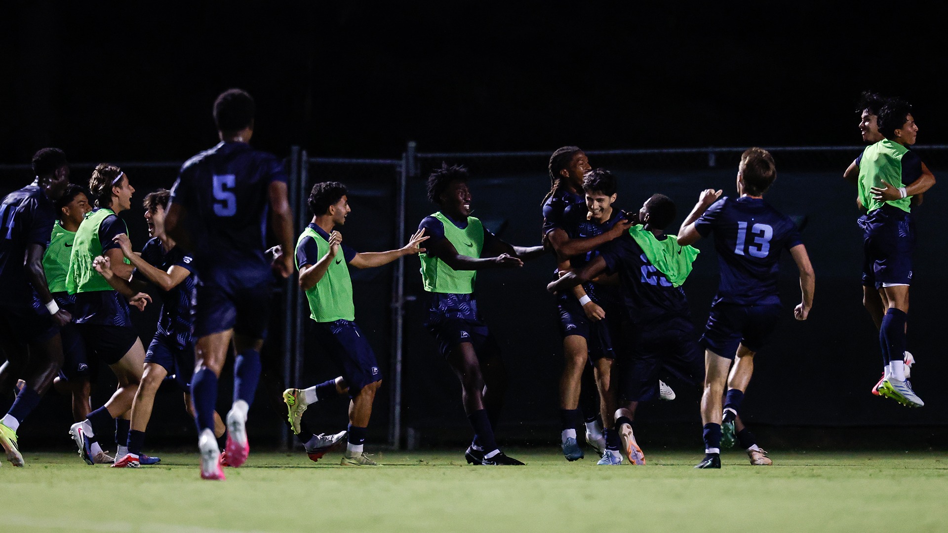 The Longwood bench celebrates with players on the field after the Lancers scored the game-winning goal in the season-opening win at William & Mary. 