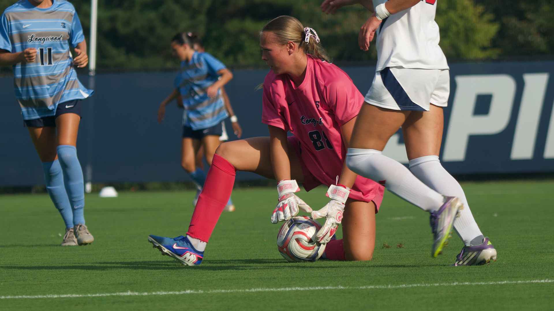 Madie Wessel picks a ball of the turf against Richmond in an September 3 match against the Spiders
