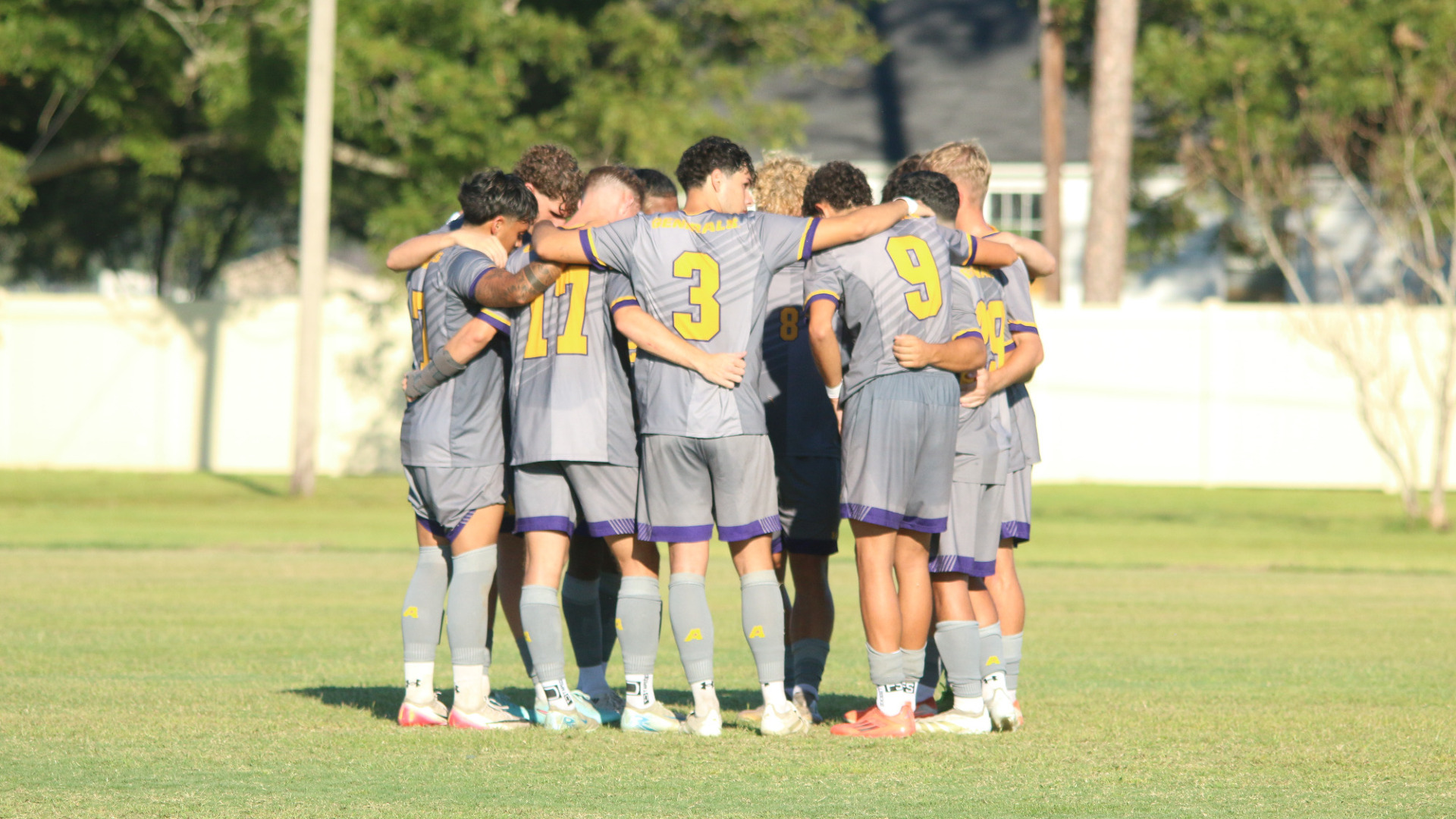 Players huddle before kickoff