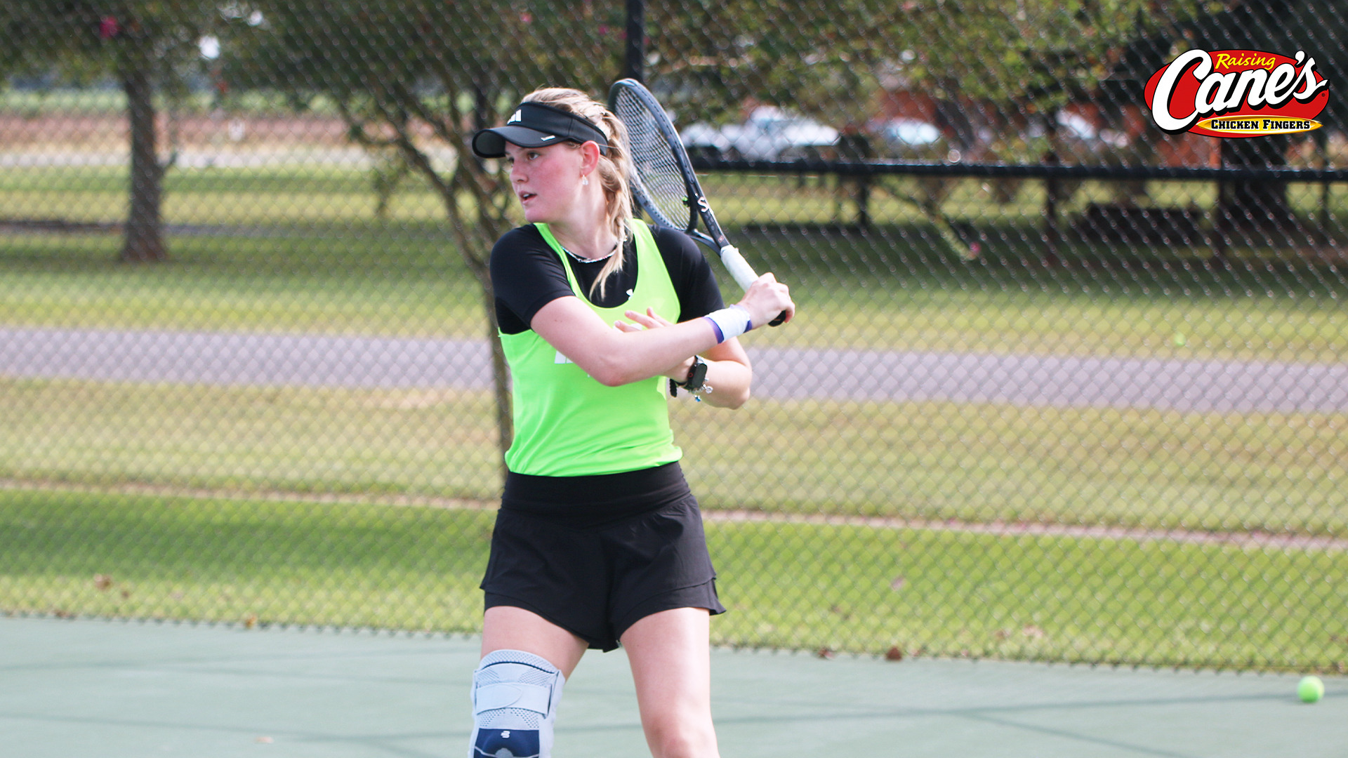 Lucie Ivanova returns a serve in practice