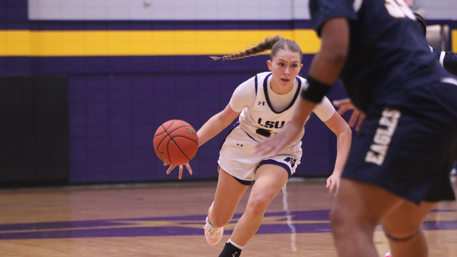 Kelly Norris drives around a defender against TAMUT