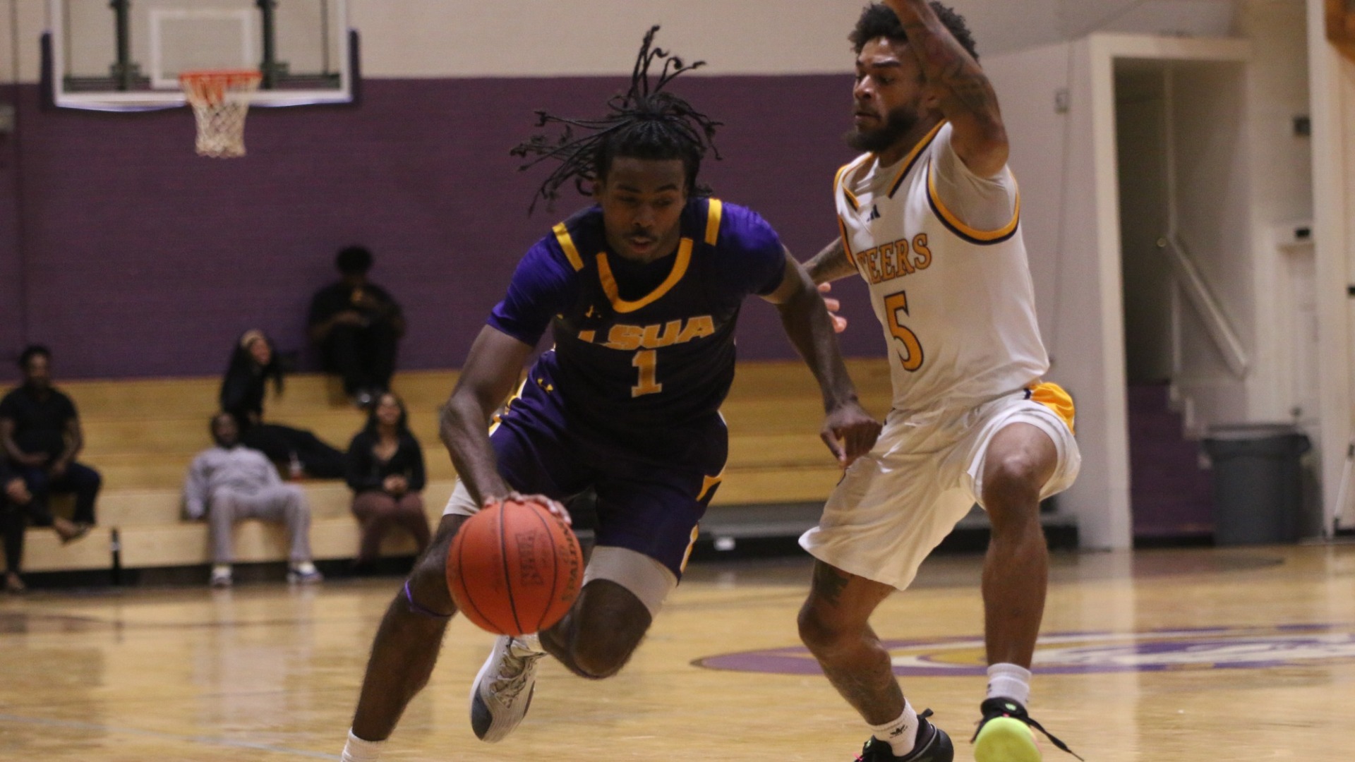 EJ McQuillan drives around a defender against Texas College