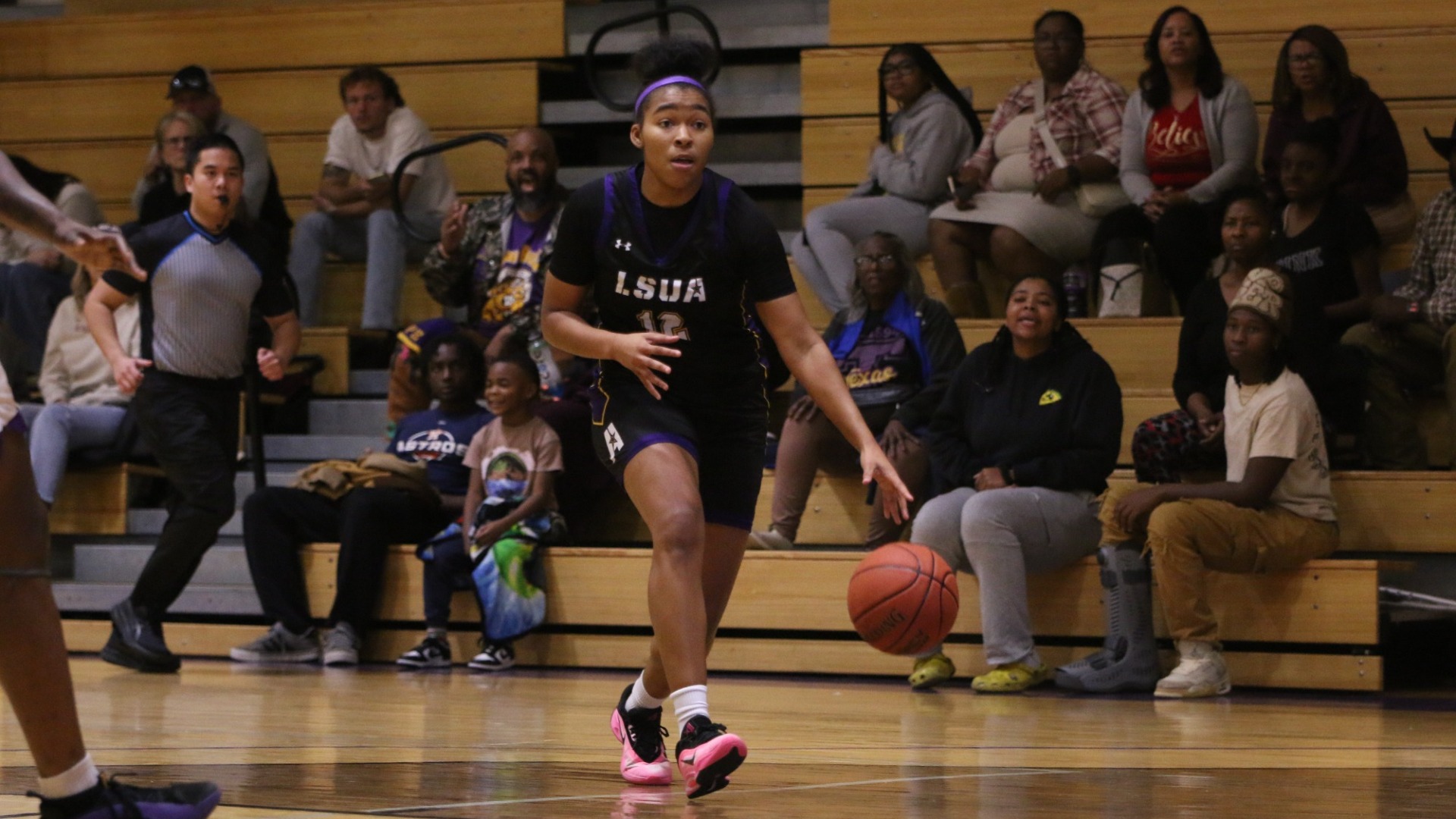 Sydney Person dribbles up court against Texas College