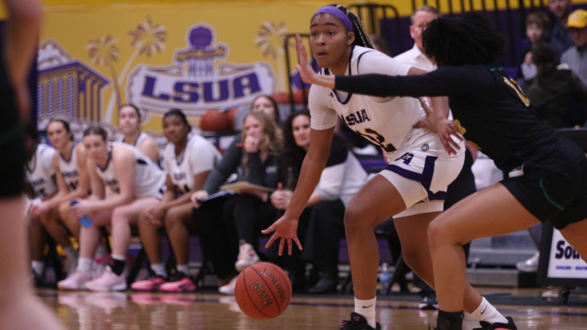 Sydney Person dribbles around an Xavier defender