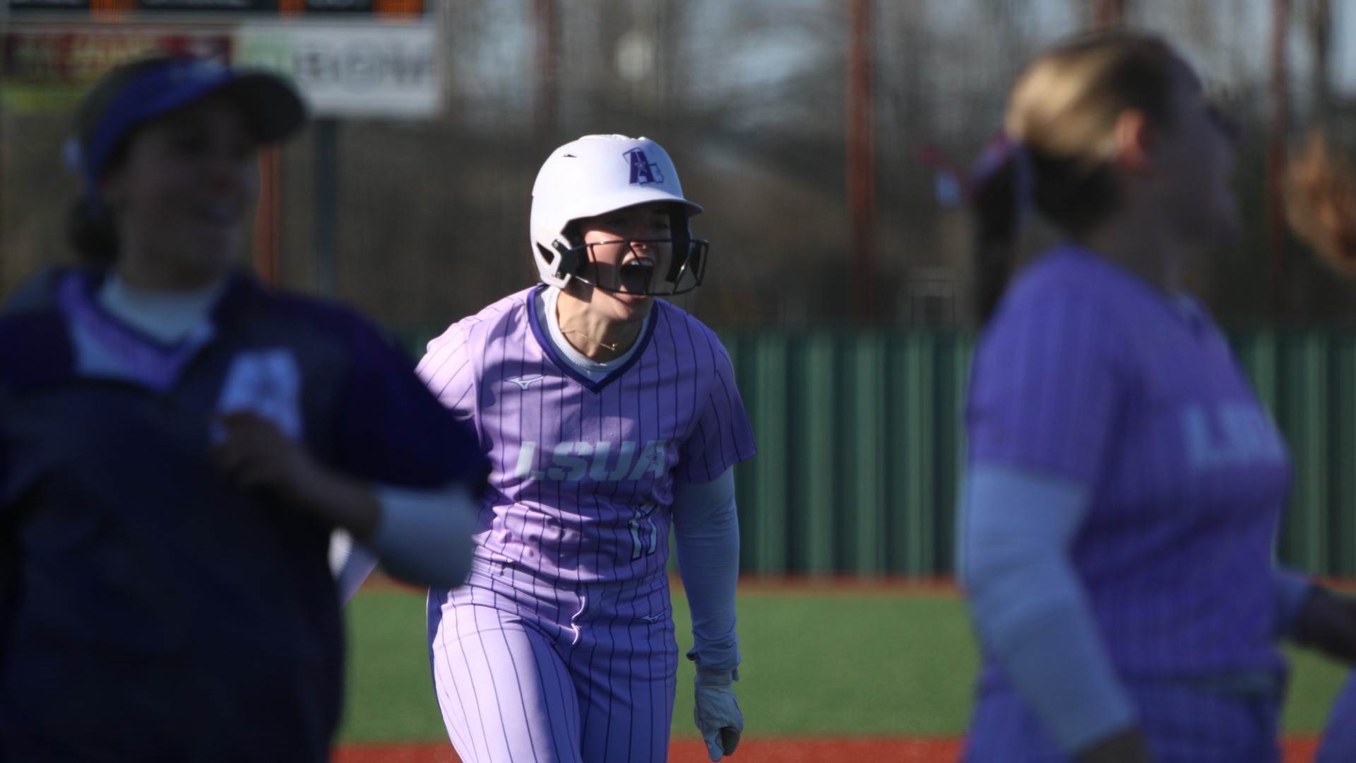 Haley Fontenot celebrates while rounding third after hitting a home run against Nelson