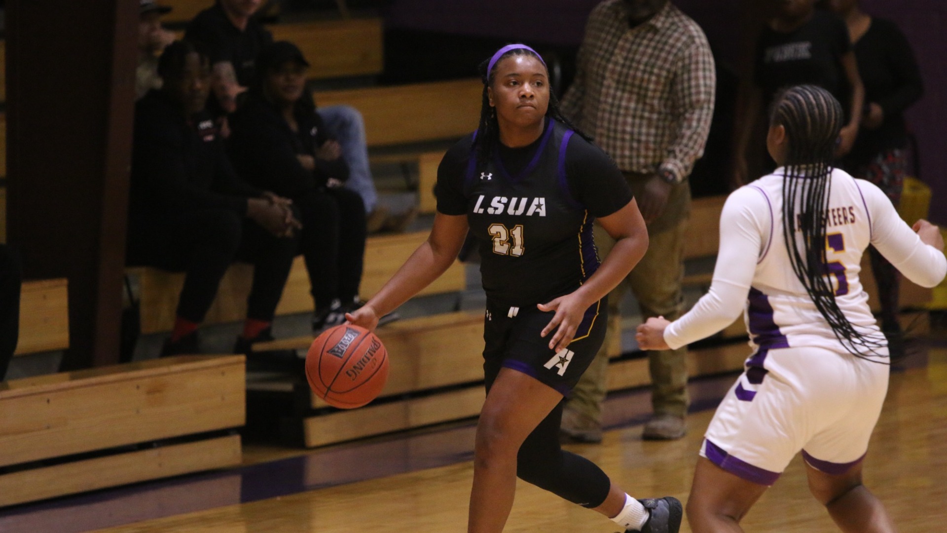 Princis Goff dribbles up court against Texas College