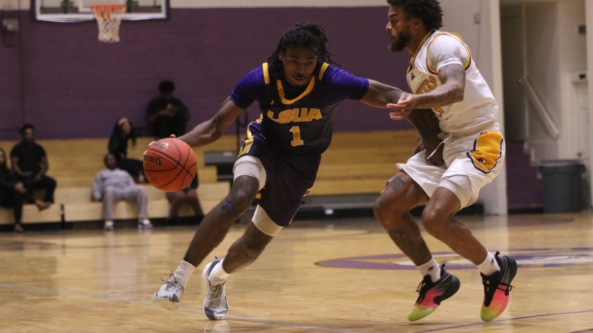 EJ McQuillan drives on a defender against Texas College