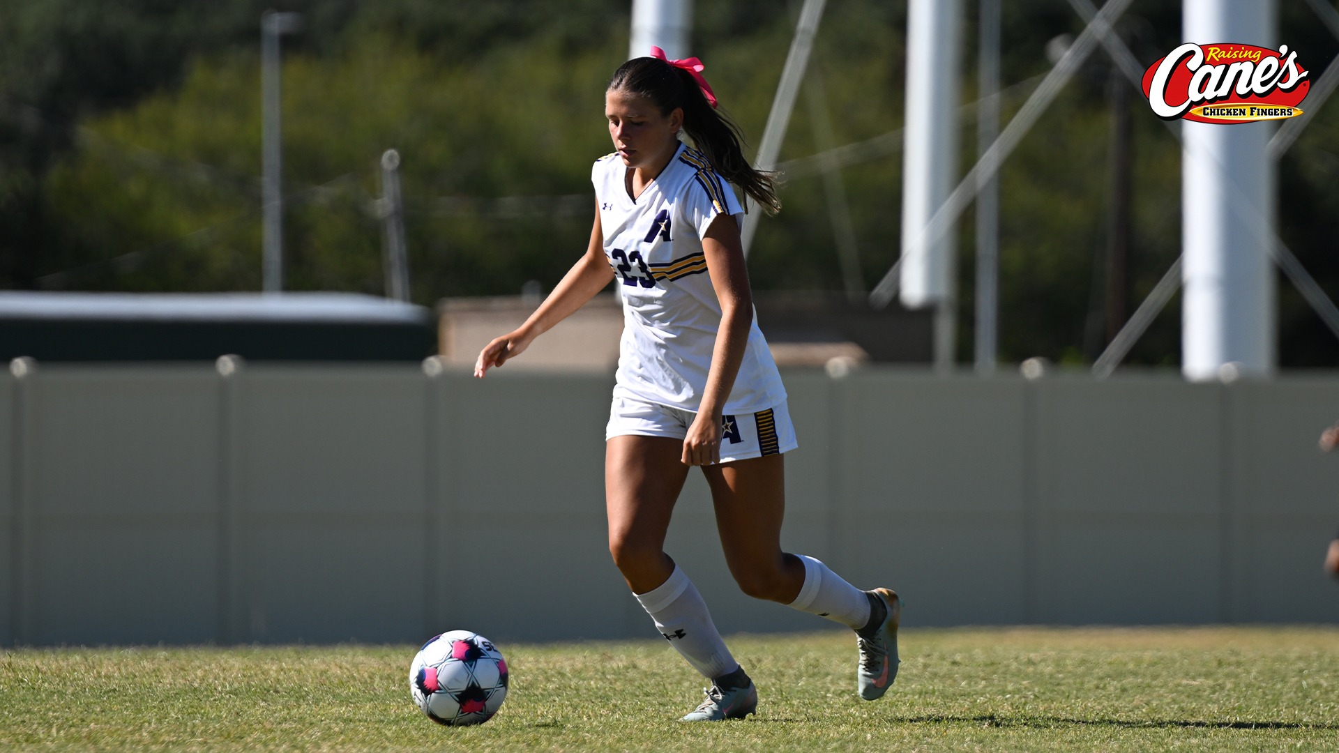 Addison Aucoin dribbles up pitch during a match