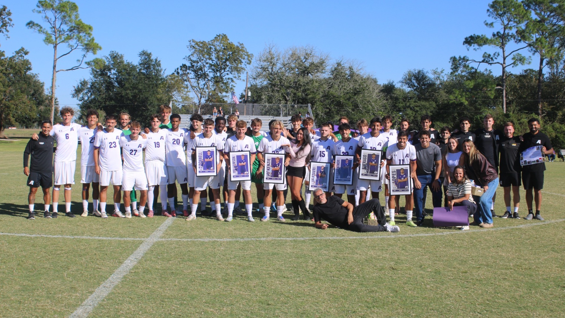 2026 Men's Soccer Seniors pose with family and friends during the senior ceremony
