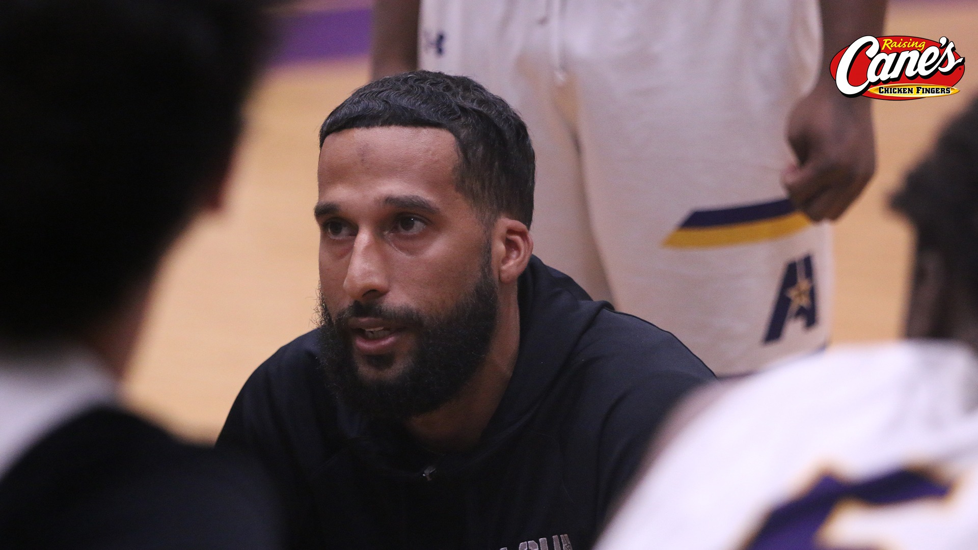 Jake DuPree talks with his team during a timeout