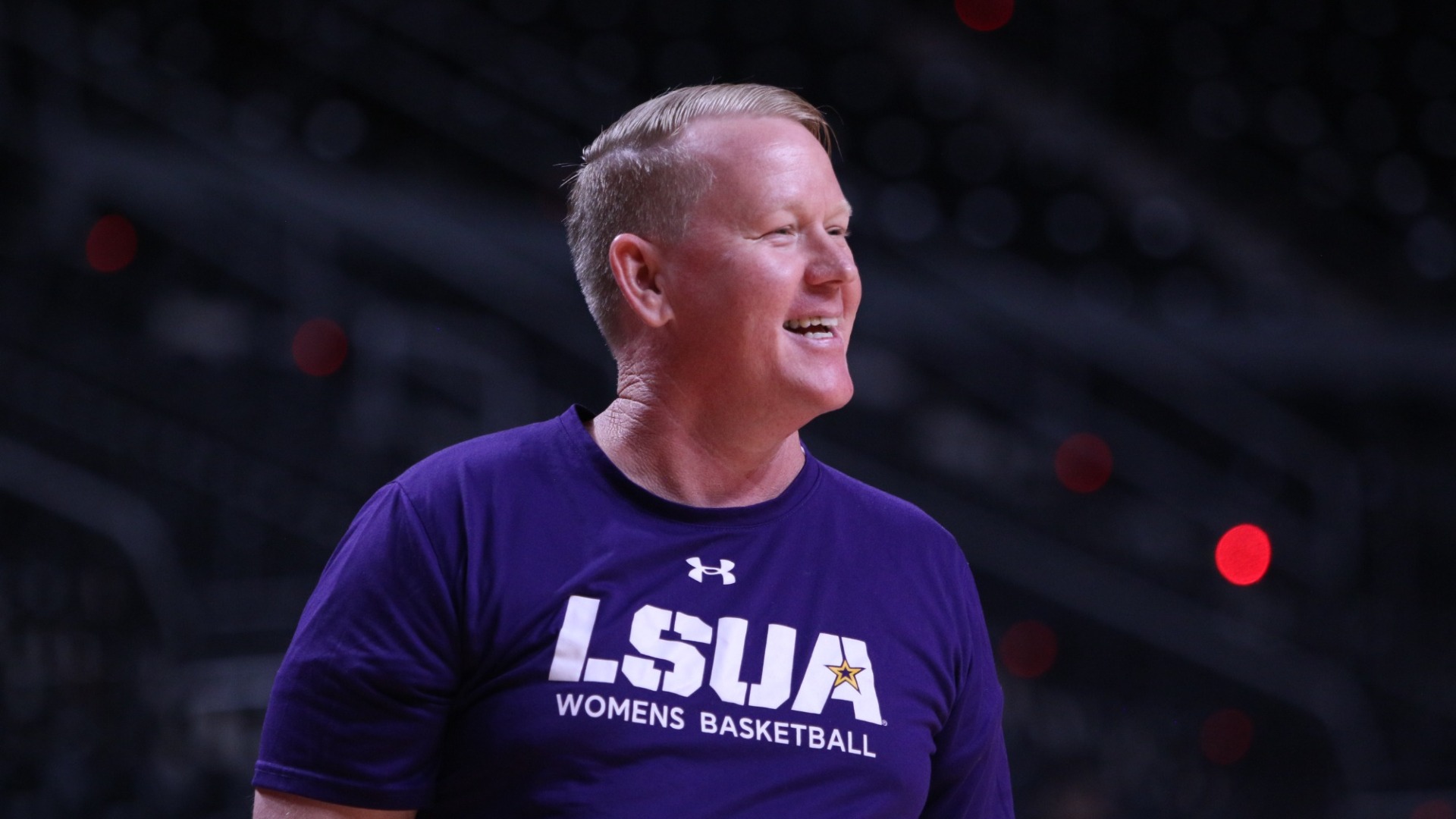 Billy Perkins smiles while coaching during a game