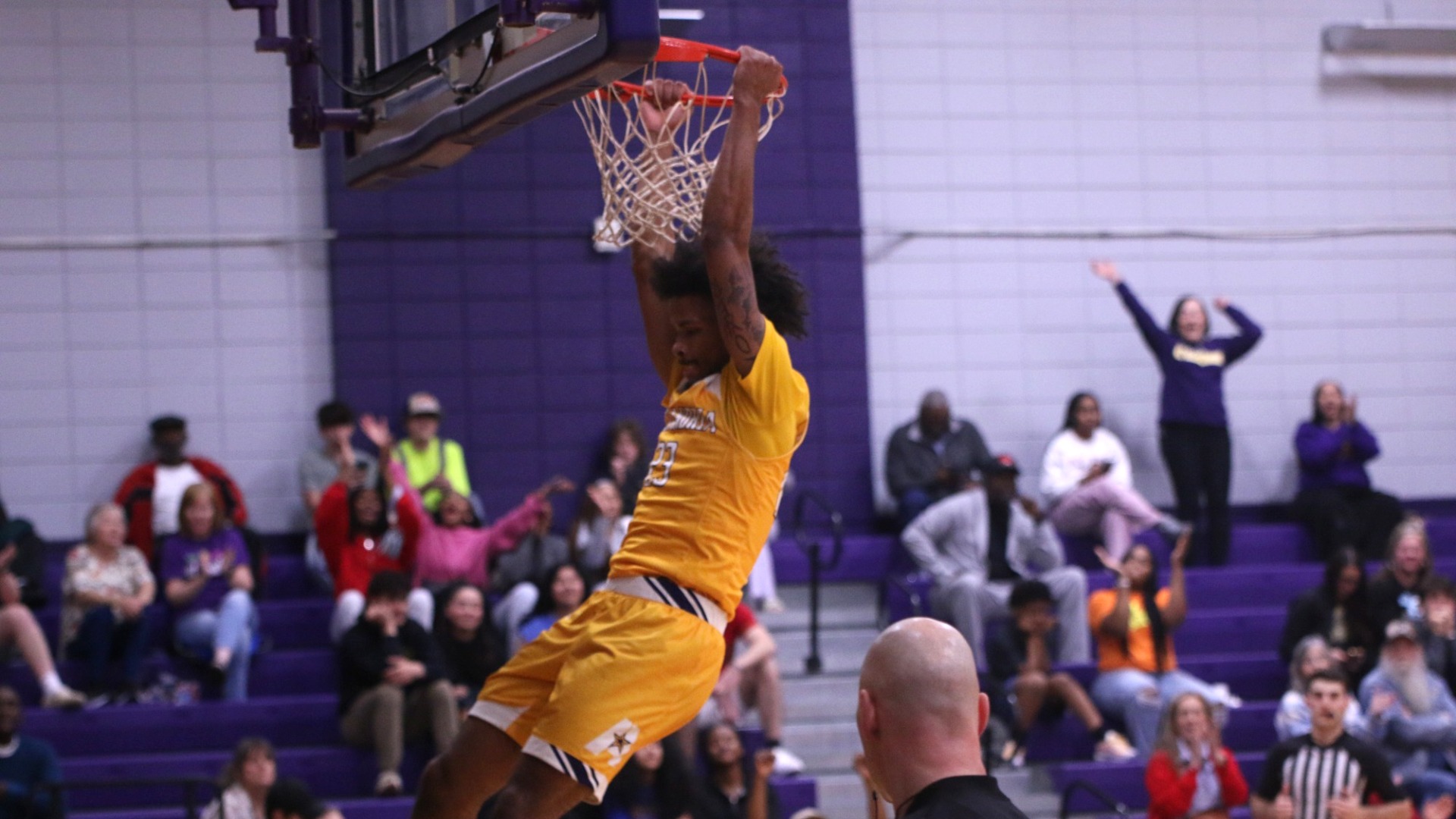 Jordan Decuir hangs from the rim after a dunk against Texas A&M-San Antonio
