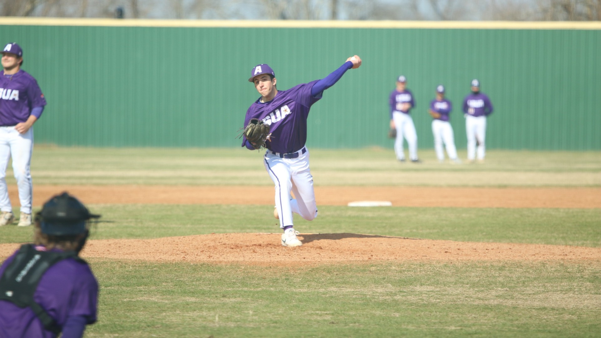 Zac Collins delivers a pitch during warmups
