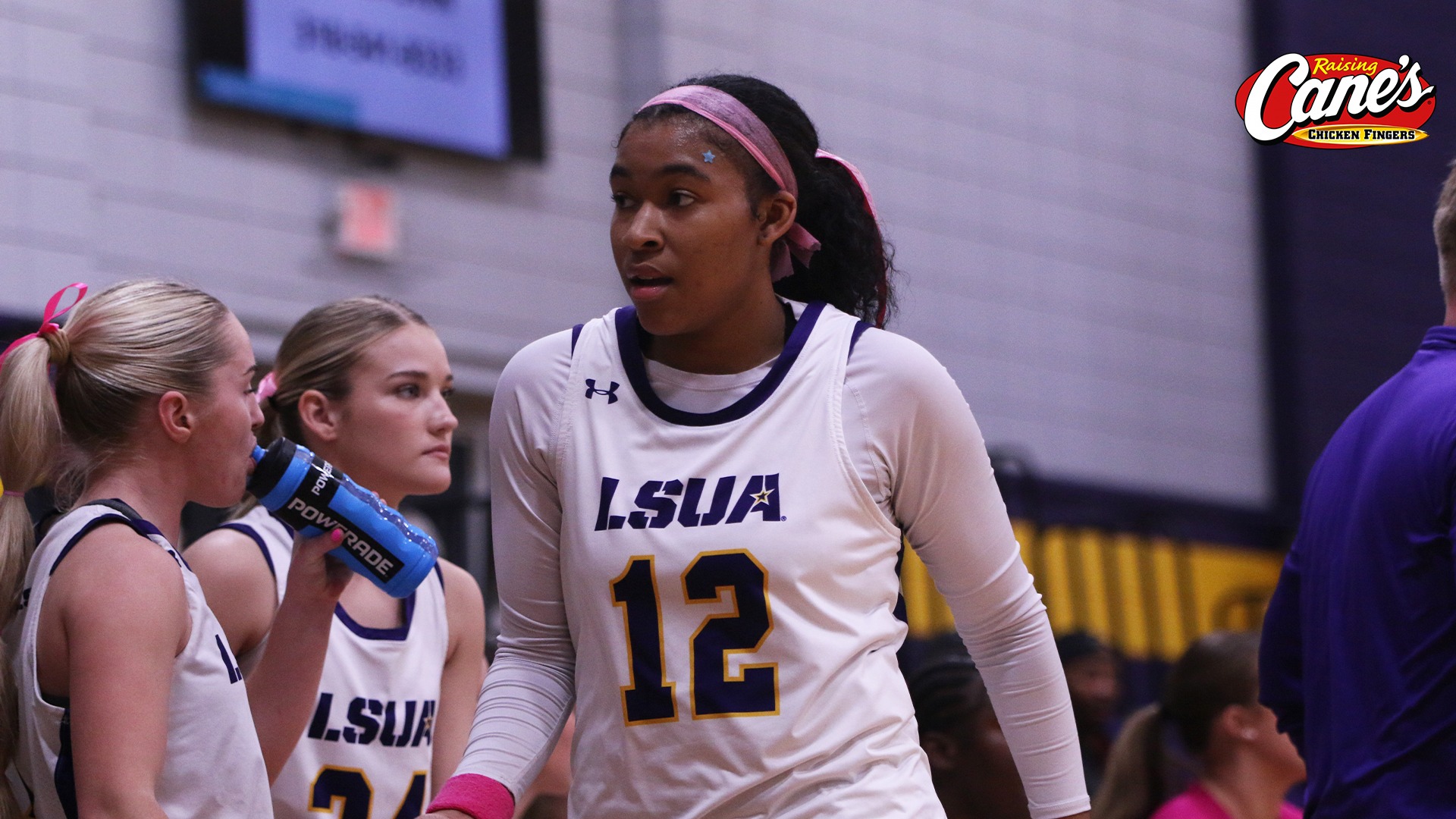 Sydney Person high fives teammates on the bench are coming off the court during a game