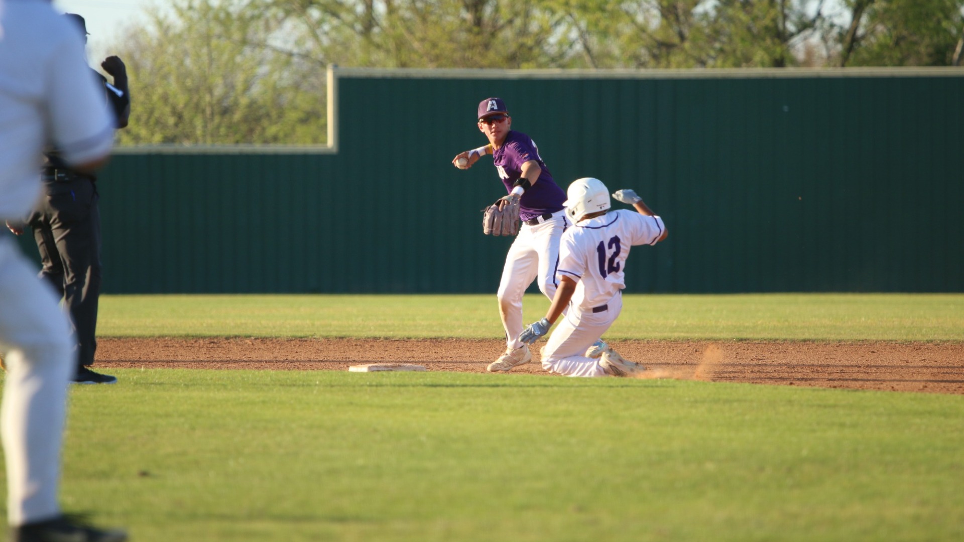 Landon Langley makes a throw to turn a 543 GDP while avoiding a sliding baserunner