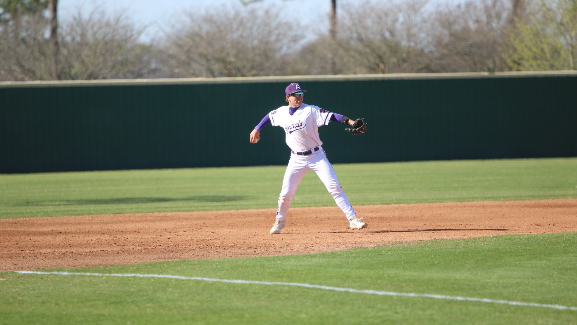 Trevor Dooley makes a throw across the infield from third base