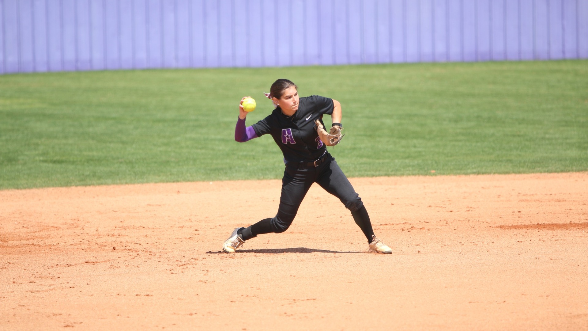 Sophia Romero makes a throw to first from third
