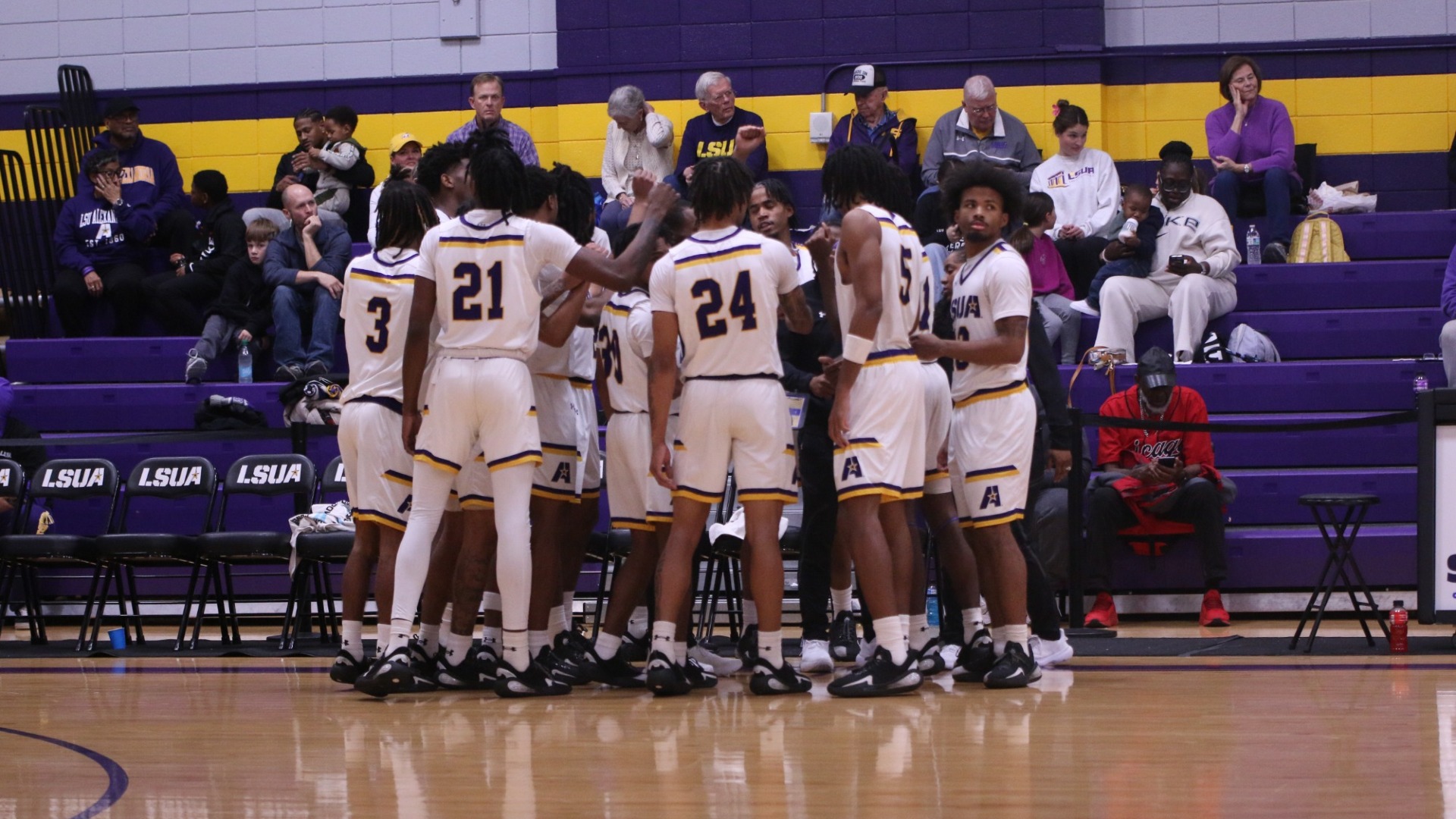 The men's basketball team huddles during a timeout