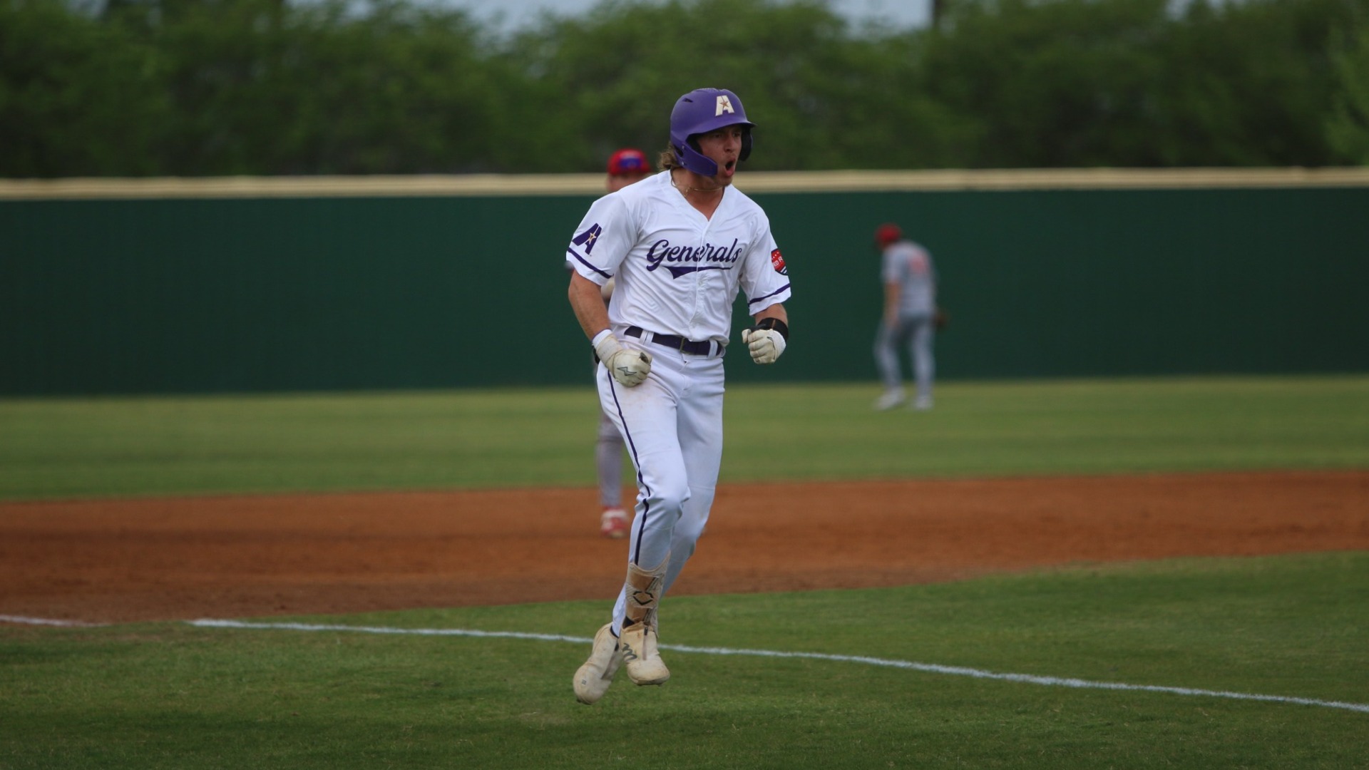 Dalton Wilson celebrates down the third base line after hitting a grand slam
