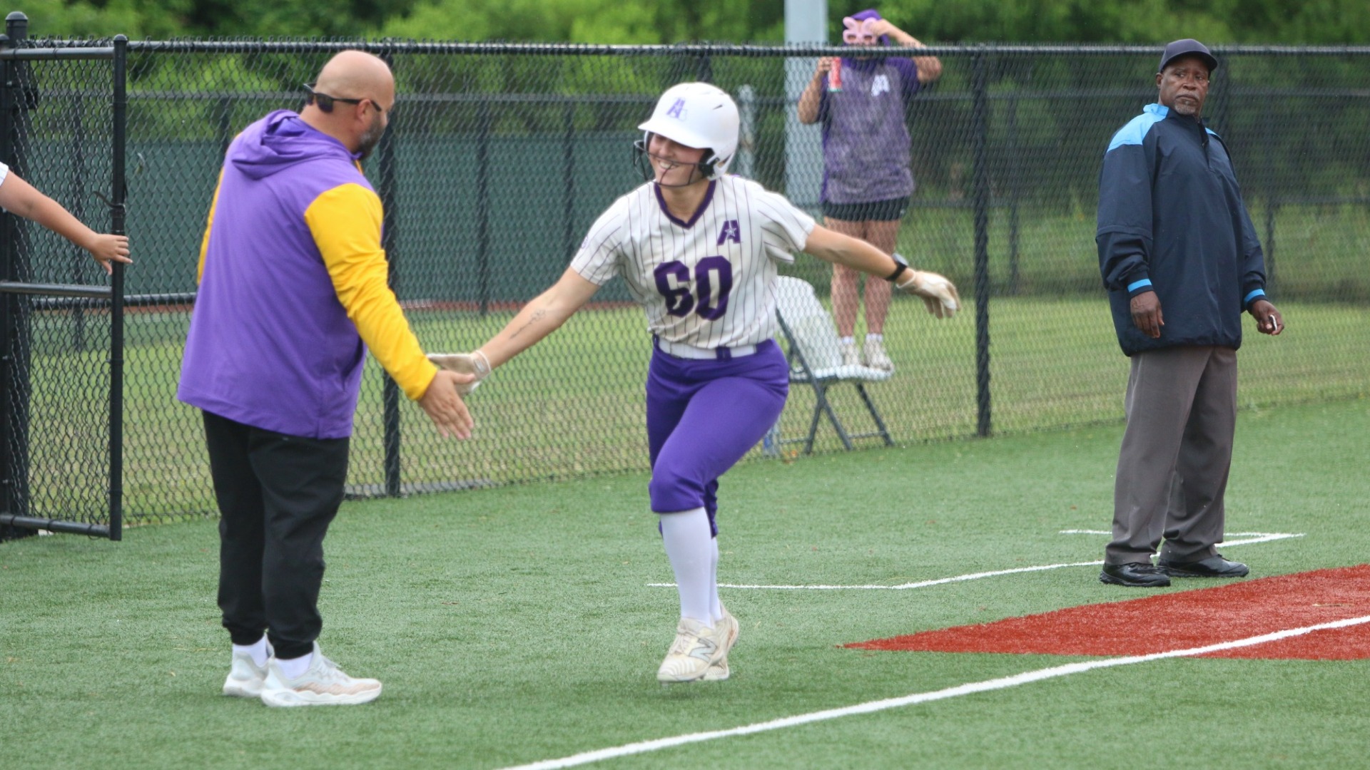 Kilee Moody high fives Brannin Hagan rounding third after a home run