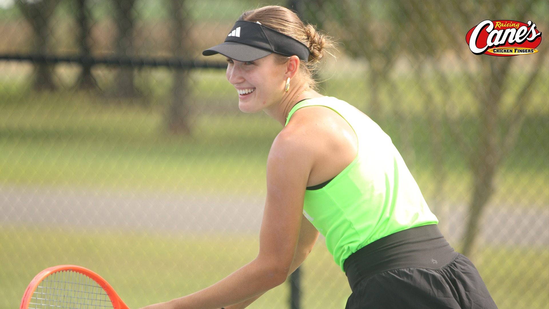 Joline Roesch smiles before hitting a servce in practice