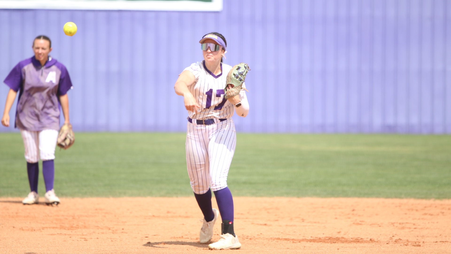 Haley Fontenot delivers a throw to home plate during warmups against OLLU